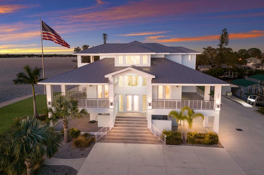 PARADISE POINT...A WATERFRONT MASTERPIECE ON THE MANATEE RIVER!!! Nestled on a PRIVATE 2.20 ACRE PENINSULA , Paradise Point is a breathtaking waterfront GATED ESTATE offering unmatched LUXURY and DIRECT ACCESS to the Manatee River, Tampa Bay and the Gulf. This 2023 custom built Key West style home boasts over 670 feet of water frontage, providing panoramic views of the Manatee River. YOU WILL NOT FIND A BETTER VALUE FOR A  NEW WATERFRONT HOME ON ACREAGE!!! Imagine absolutely stunning sunrises followed by even more beautiful sunsets in the evening, all while sitting on your multiple covered lanais on each level of the house! Truly a Home of Luxury & Comfort. Spanning nearly 6,000 square feet of air-conditioned space , with a total of over 12,800 square feet including porches and garage space, this home is designed for both relaxation and grand entertaining. The open-concept living area showcases expansive water views out of almost every room. As soon as you enter the main living area you will notice the high ceilings and natural light streaming in thru all the windows in the great room. The gourmet kitchen is a chef’s dream, featuring Wolf and Thermador appliances, gorgeous shaker style cabinetry, dual dishwashers, and a huge island that is the perfect spot for hosting gatherings. Take the stairs or elevator to the private third-floor owner’s suite. Truly a serene retreat, complete with a spacious lanai with cypress ceilings, two oversized walk-in closets, and a spa like bathroom featuring a Jacuzzi soaking tub and a 12’x8’ Thermosol wet sauna steam shower. The main level offers four additional bedrooms, including one ideal for a home office. A 15-person theater room on the first floor elevates the home’s entertainment experience. The 6 car garage is huge and offers endless possibilities for the car enthusiasts or just for those looking for storage. Built for absolute strength, this home was constructed way beyond standard building codes! This estate is engineered for maximum durability and energy efficiency. With a completely solid block structure, reinforced concrete floors, a fire sprinkler system, and state-of-the-art roofing material with polyurethane insulation, it provides superior storm resistance. Its high elevation has ensured it remains completely dry through past hurricanes, offering unparalleled security and peace of mind! The exterior is truly an outdoor paradise for boating & entertaining! Designed for those who love the water, this estate features plenty of dock space along a protected deepwater lagoon. You can tell that this area was designed by someone with lots of experience on the water and that they constructed this area with an open check book!  Featuring trex decking, built in dock lighting and two private covered boat slips—one with a 16,000 lb lift and the other with a 10,000 lb lift—as well as a concrete shed to store all your boating/fishing gear and your ice machine! Additionally there is a fish cleaning station and shore power at the dock. Truly a dream set up!! Conveniently located just minutes from downtown Bradenton, this estate is near top-tier schools, including IMG ACADEMY, ST STEPHENS AND BRADENTON CHRISTIAN SCHOOL!  Only minutes to the Gulf Beaches of Anna Maria Island, short distance to downtown St. Pete and the cultural & culinary arts of Sarasota. TRULY AN AMAZING LOCATION WITH EASY ACCESS TO SO MANY OPTIONS!