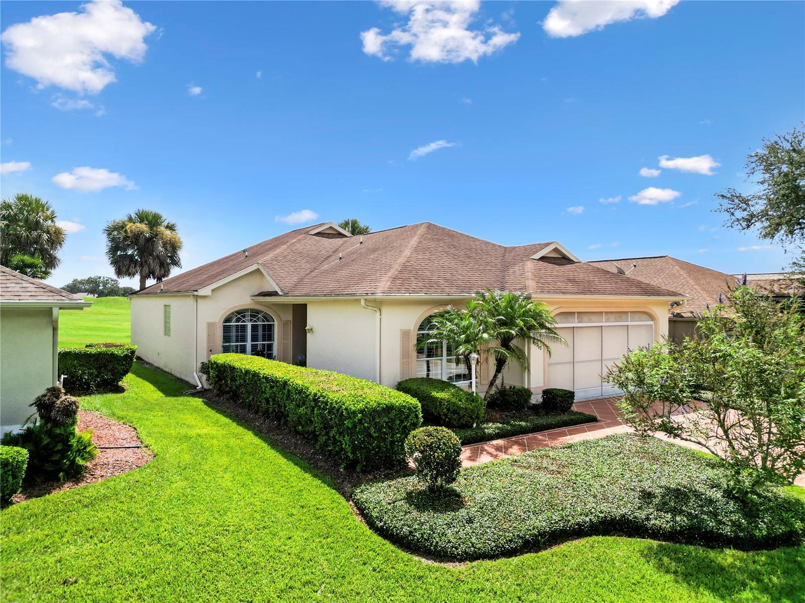 THIS HOME IS PRICED TO SELL! Located in STONECREST, a 55+ gated community with 4 pools, golf course and many amenities. Close to THE VILLAGES. Access by golf cart to restaurants, doctors, shopping and much more! Large lanai overlooking the FIRST FAIRWAY OF THE GOLF COURSE! This block and stucco villa has 1922 sq ft of living space, a split floor plan, 3 BR, high vaulted ceilings, large kitchen with plenty of cabinets and a breakfast nook and a spacious dining room. You won't have to worry about lawncare, it is included in the Villa amenities charge.