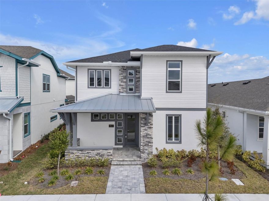 The Santorini floor plan is an elegant balance of livability, bold design, and classic style. This two-story home includes four generously sized bedrooms and three and a half bathrooms, thoughtfully arranged to maximize both comfort and function. A welcoming foyer greets you at the entrance, creating an immediate sense of openness and natural light that carries throughout the home.
At the center of the layout is a seamless open-concept living space where the kitchen, dining area, and family room connect effortlessly. The kitchen is designed for both everyday living and entertaining, complete with an oversized island, premium appliances, and abundant cabinet storage. The dining space transitions smoothly into the living area, which has plenty of room for large seating arrangements. Expansive windows brighten the space and provide views of the lanai just outside.
The primary suite, conveniently located on the first floor, serves as a peaceful escape. Spacious enough to accommodate a king-sized bed and optional sitting area, it combines privacy with comfort. The en-suite bathroom features dual sinks, a sizable walk-in shower, and an expansive walk-in closet. Positioned away from the main gathering areas, the suite provides a quiet and restful atmosphere.
Upstairs, three additional bedrooms provide comfortable accommodations for family or guests. Two bedrooms share a practical Jack-and-Jill bathroom, while the third has easy access to another full bath. A spacious game room anchors the second level, movie nights, a play area, or a hobby space. The open-to-below feature enhances the home’s airy feel, allowing light to travel freely between both floors.