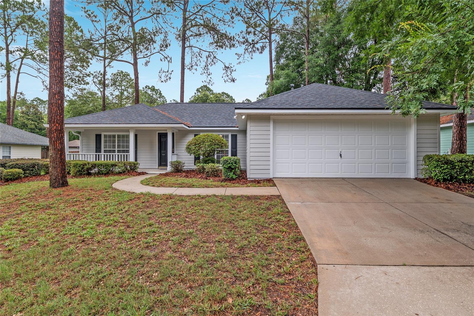 One or more photo(s) has been virtually staged. Step inside this 3 bedroom, 2 bathroom home in Mentone and you’ll immediately feel the care that’s gone into this well-maintained, move-in-ready space. The layout is both functional and inviting—walk through the front door to find a flexible space to your left that works great as a home office or den, and a formal dining area to your right. Straight ahead, the spacious living room features vaulted ceilings and opens seamlessly to the kitchen and breakfast nook, creating the perfect central hub for daily living and entertaining. This home has seen a major refresh in 2025 with brand new luxury vinyl plank flooring throughout the living areas and bedrooms, fresh interior and exterior paint, new light fixtures, door hardware, and a stylish living room ceiling fan. Both bathrooms feature new tile flooring, and the kitchen shines with 2024 stainless steel appliances—fridge, range, microwave, and dishwasher. The HVAC system was replaced in 2024, and the roof was just done in 2025—so all the big-ticket items are taken care of. The private owner’s suite features an ensuite bath with a double vanity, soaking tub, and separate shower, along with a spacious walk-in closet. All three bedrooms have ceiling fans, and the two guest rooms offer custom closet shelving and great natural light. Additional highlights include an indoor laundry room, 2-car garage, a welcoming front porch, a screened lanai, and an open back patio—great for grilling or relaxing outdoors. The home sits on a quiet, low-traffic street, offering extra peace and privacy. In the highly sought-after community of Mentone, you’ll enjoy a heated neighborhood pool, kiddie pool, pavilion, and pickleball on the tennis courts, plus a basketball court, playground, and walking trails—all with low HOA fees. Just minutes from UF, Shands, Celebration Pointe, Butler Plaza, and all the best of Gainesville. And best of all, it’s on Clay Electric.