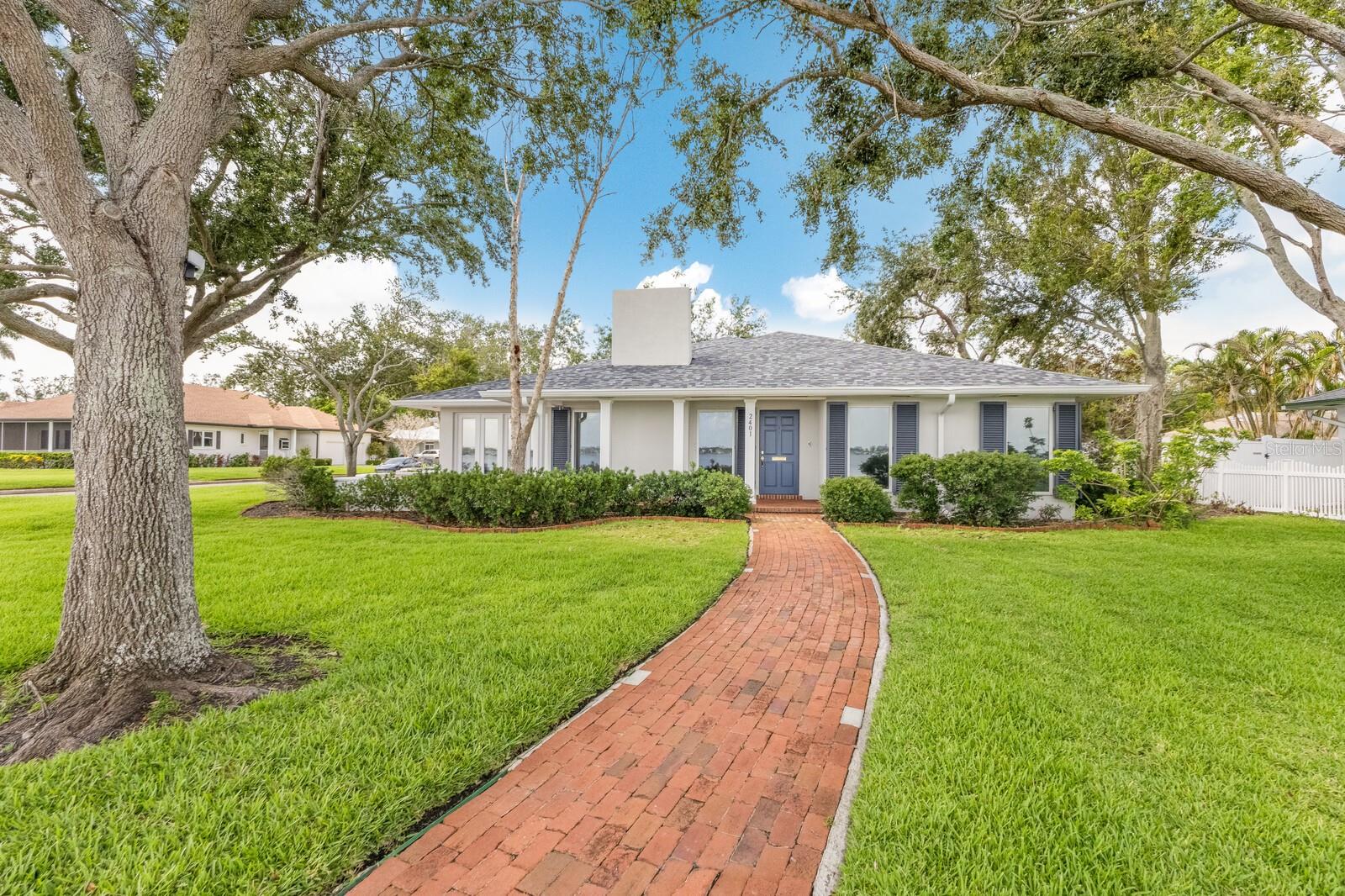 One or more photo(s) has been virtually staged. RIVERFRONT POOL HOME WITH STUNNING VIEWS IN THE HEART OF BRADENTON’S RIVER DISTRICT! Welcome to this beautifully updated residence located directly on prestigious Riverview Boulevard, where timeless charm meets contemporary elegance. Nestled in the highly sought-after River District, this exceptional home offers over 2,600 square feet of refined living space, with breathtaking, unobstructed views of the Manatee River from nearly every room. Lovingly remodeled to meet today’s highest standards, the home features recent upgrades including all-new flooring, brand new kitchen, a new hot water heater, new pool pump, a newer roof (6 years), and a newer AC system (5 years). Step inside to discover a bright, open floor plan designed for both everyday living and effortless entertaining. Walls of oversized windows flood the home with natural light and frame postcard-perfect views of the river and surrounding mature oak trees. At the heart of the home is a fully renovated chef’s kitchen that blends style and function. Everything is new! Crisp white shaker cabinetry, gleaming quartz countertops, and a full suite of premium stainless steel appliances—including a gas cooktop, double ovens, microwave, refrigerator, and dishwasher—make this space a dream for any culinary enthusiast. A large center island provides ample prep and gathering space, while wide-plank luxury vinyl flooring and recessed lighting add warmth and sophistication. The open-concept living and dining areas offer a seamless flow for entertaining, anchored by a classic fireplace for cozy evenings. Just off the main living area, a dedicated library or office space provides a quiet retreat or a stylish work-from-home setup. The spacious primary suite is a serene escape, bathed in natural light and views of the gorgeous yard. The en-suite bath features a double vanity with ample storage and counter space, offering both functionality and spa-like comfort. Two additional oversized bedrooms ensure plenty of room for family or guests. Outside, your private backyard oasis awaits. A brick-paver patio offers a shaded area for alfresco dining or lounging, while the sparkling pool and lush landscaping create the perfect setting for relaxation or entertaining—just steps from the riverfront. Additionally the owners have a custom made child safety fence for small children around the pool. Best of all, this home comes with no HOA or deed restrictions, giving you freedom and flexibility. Unbeatable location on the River- easy access by boat to multiple restaurants, the yacht club and world class fishing! Located just minutes from vibrant downtown Bradenton, you’ll enjoy easy access to Riverwalk Park, local farmers markets, fine dining, and more. And for beach lovers, the world-famous shores of Anna Maria Island are only a short drive away. This rare riverfront gem offers an unbeatable combination of location, luxury, and lifestyle—don’t miss your chance to call it home!!!