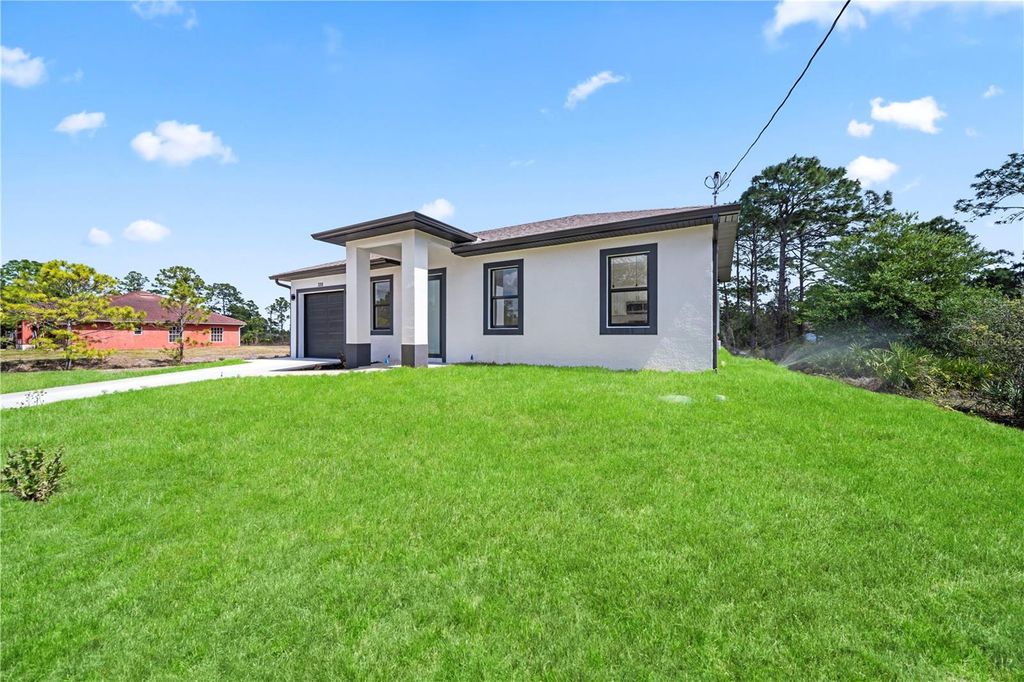 Photo of 326 Louis Avenue, Lehigh Acres, FL 33936 (MLS # TB8487542)