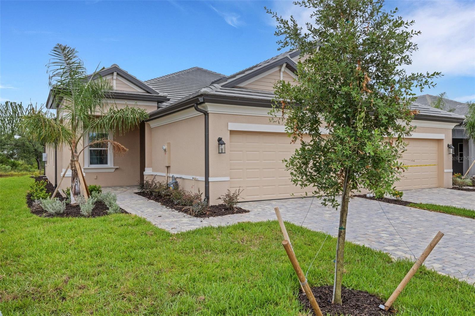 Welcome to Sweetwater at Lakewood Ranch! Step into the Florida lifestyle and luxury with this exquisite brand new/never lived in two-bedroom, two-bathroom villa that includes a den and a spacious two-car garage. As you enter through the grand foyer, you're greeted by a layout designed for both elegance and functionality. The home is designed with zero wasted space and is perfect for family gatherings and entertaining. With its open, light and bright integrated floor plan, the home has tons of natural light! The great room, adorned with a stunning tray ceiling, beckons you to unwind and relax in style. Calling all chefs of the family! Prepare to be dazzled by the kitchen as this culinary haven boasts a spacious layout featuring a large island and top-of-the-line appliances that will elevate your cooking experience to new heights. Feel the thrill as you cook with natural gas, ensuring precision and control over your culinary creations. With ample counter space and an abundance of cabinets, organizing ingredients and kitchen gadgets is a breeze. Whether you're whipping up a gourmet meal for guests or preparing a cozy family dinner, this kitchen is your ultimate stage for culinary creativity and delight! The owner's suite is your sanctuary, featuring a sizable walk-in closet and a luxurious bathroom with dual vanities and a walk-in shower that promises pure indulgence. Need a home office or study space? The den, conveniently located off the foyer, is just the spot! The kitchen is a chef's dream, seamlessly flowing into the dining area, making it perfect for hosting gatherings and entertaining friends and family.A second bedroom and bathroom ensure comfort and privacy for guests, making them feel right at home. Slide open the glass doors to the covered lanai and imagine yourself enjoying the delightful Florida weather year-round. Sweetwater at Lakewood Ranch isn't just a community; it's a lifestyle! Nestled in southeastern Manatee County, this gated, maintenance-free community offers sweeping views of Florida's natural beauty. Enjoy top-notch recreational activities, excellent medical facilities, local farmer's markets, and premier shopping—all within 50 square miles. Sweetwater is your gateway to the best attractions and beaches in the area. Live where others vacation, and experience the ultimate in Florida living at Sweetwater at Lakewood Ranch. ** THE BUILDER IS OFFERING SEVERAL VERY ATTRACTIVE BUYER INCENTIVES LIKE LOW INTEREST RATES AND CLOSING COST INCENTIVES