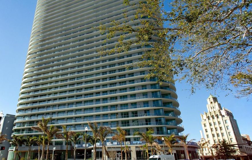 One or more photo(s) has been virtually staged. A statement of success—panoramic views and refined living from one of St. Petersburg’s most prestigious towers, in the vibrant heart of downtown. This refined 3-bedroom, 3.5-bath residence at 400 Central features 10’ ceilings and walls of glass that flood the home with natural light. An expansive wrap around terrace spans the full length of the residence, offering seamless indoor-outdoor living and panoramic views from the living area and all 3 bedrooms.
The gourmet kitchen highlights Italian cabinetry with under-cabinet lighting, quartz countertops, and JennAir stainless appliances, including a 36" gas cooktop and refrigerator. The owner’s suite bath features an enclosed glass shower with multiple shower heads, Grohe fixtures, and a Calcutta-pattern backsplash. Prestige Dolomiti matte tile throughout, Whirlpool washer/dryer, built-in medicine cabinets with adjustable lighting and time display, and pre-wiring for electronic shades.
Residents enjoy over 36,000 SF of amenities, including a resort-style heated pool, fitness center, Zen garden, cabanas, theater lounge, private dining room, and a 45th-floor Sky Lounge with 360° views of Tampa Bay and the Gulf. Maintenance-free, lock-and-leave living in the heart of downtown St. Petersburg.