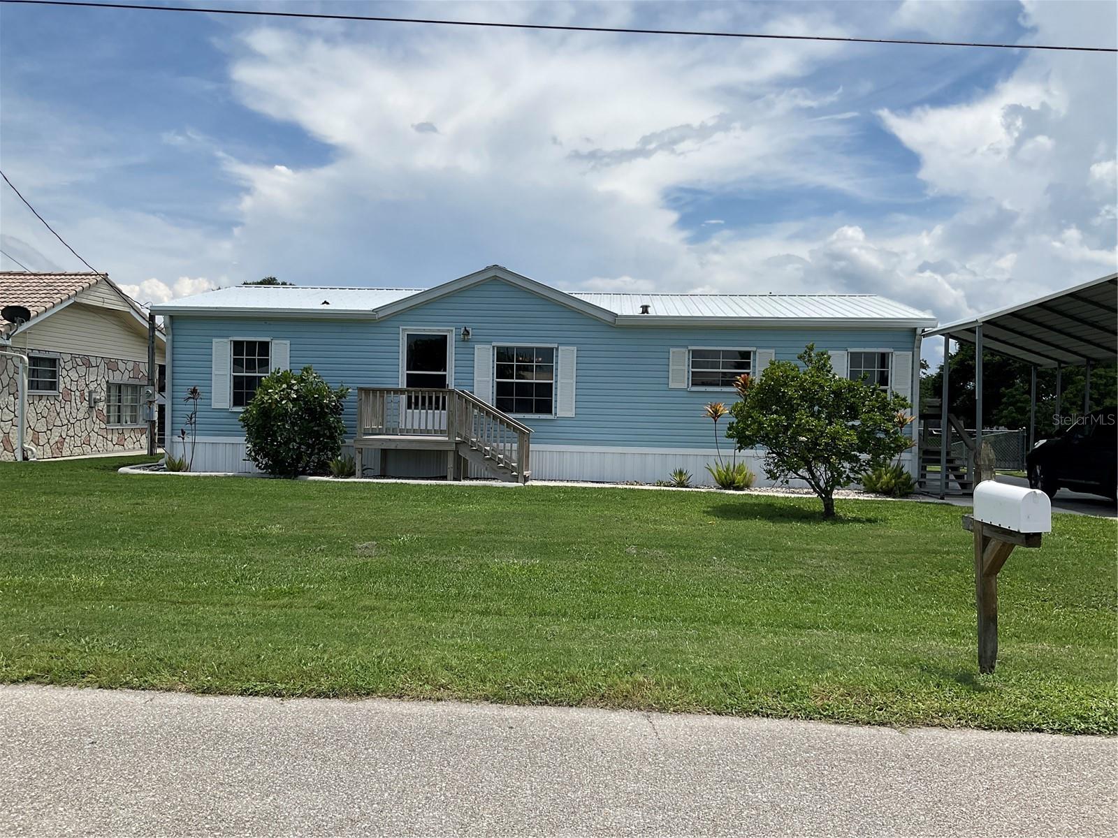 Taylor Creek Isles- Lake Okeechobee Access- 3 bedroom - 2 bath with huge Florida room overlooking Canal and Boat House. Features include open floorplan- Metal Roof- Central A/C- New 2025 2-ton Mini Split in Florida room, Beautiful Laminate flooring thru out-Solid wood cabinets- inside storage room-shed- Boat house with new lift- good seawall- fenced in yard- hurricane shutters- updated plumbing-and more. A must see call today! all measurements are approximate.