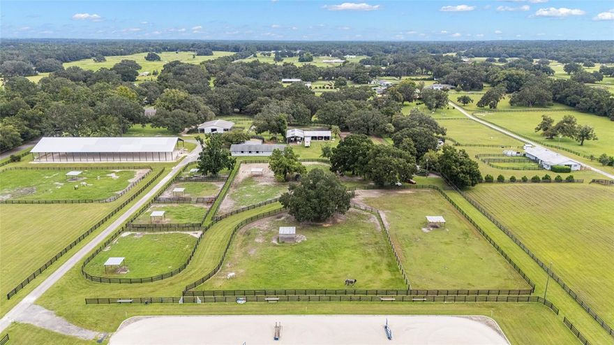 HUGE Price Improvement.. Working Horse Farm! An exceptional opportunity to own a fully functioning horse farm / training facility in a perfect location in NW Marion County, 20 minutes to the World Equestrian Center, 7 minutes to HITS, 10 minutes to Barnstaple & Sweet Dixie! This premier equestrian property features Two residences, Main pool home, 3-3 and Guest cottage 3-2, as well as Two well-equipped Center aisle Barns, Barn 2 is equipped with run-outs. All this offering flexibility for owners, trainers, staff, or income-producing potential. This is a well-maintained farm and does consist of two parcels being sold together. You will notice the rolling acreage, mature trees, along with paddocks and pastures that provide both beauty and usability, with thoughtfully designed and professional-grade equestrian facilities. The farm is equipped with a covered arena with mirrors, an outdoor Wordley Martin arena (250x150), and a cross-country schooling field including water complex, ditch and banks, making it an eventer’s dream yet suitable for multiple disciplines as well. Whether preparing for competition or daily schooling, the layout supports an active and efficient horse operation. Designed for serious equestrians, this working farm combines location, infrastructure, and versatility. With proximity to world-class events, shows, and amenities, it is ideal for trainers, competitors, or investors seeking a turnkey equestrian property in a highly desirable area. Extra features such as Garage with studio apartment, 3 bay workshop, covered trailer parking, shavings storage, round pen, 4 RV hook ups, 2 commercial Speed Queen barn washing machines, and too many more to list! Possible Seller financing on smaller parcel.