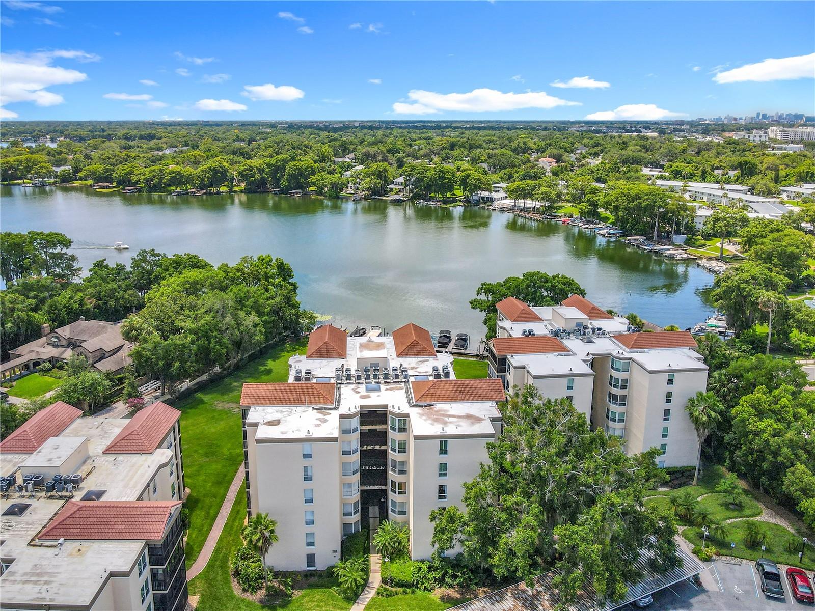 Here's your chance to own an amazing penthouse condo in the sought after community, "The Moorings on Lake Maitland". Stunning high-end updates to this corner unit with vaulted ceilings and breath taking lake views include, wood floors, custom moldings and millwork, plantation shutters, completely updated kitchen (which has been redesigned to expand into the living space), solid wood cabinetry, Australian quartzite counters, mosaic backsplash, GE Profile SS appliances and an eat-in nook. The glassed-in lanai adds even more to the living space with gorgeous views of the early morning sunrise and evening moonrise over Lake Maitland, part the Winter Park Chain of Lakes. Split bedroom plan provides maximum privacy. Primary suite which opens to the lanai has fully updated bath, dual sinks, step-in shower and a spacious walk-in closet. Fully equipped laundry room, and updated spacious guest bath. So many wonderful details including lots of storage in the custom designed closets throughout and a storage room just outside the unit on the landing, within close proximity to the elevator. New AC in 2021, Reroof 2021, Structural Weatherproofing 2022, Assigned Covered Parking Space, Pool, Spa & Club House Updates. ALL THIS & walkabililty to countless restaurants and shopping!! Schedule a showing now! This one won't last!
