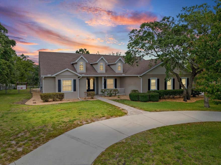 Welcome to your private Florida retreat on just under one acre with a fully fenced backyard, no rear neighbors, and room for everyone, all with NO HOA and NO FLOOD ZONE concerns. This beautifully maintained 4-bedroom, 2-bathroom home with an oversized 3-car garage offers the perfect combination of indoor comfort and outdoor living.  As you enter through the double front doors, you are greeted by a light and bright foyer with immediate views through the fully retractable triple sliding glass doors that disappear behind the wall, seamlessly blending indoor and outdoor living. Step outside to the huge SCREENED LANAI with sealed pavers overlooking the resurfaced SALTWATER POOL (2022), complete with a pool shower, pergola, fire pit area, and a 220-amp outlet ready for a future spa.  The spacious split floor plan provides privacy and functionality. The primary suite is tucked away on the left side of the home and features two large walk-in closets, dual sink vanities with separate counter spaces, a garden tub, walk-in shower, and private water closet. Bedroom four is located near the front entry and is ideal for a home office, guest room, or flex space.  The kitchen is designed for both entertaining and everyday living with granite countertops, breakfast bar seating, stainless steel appliances, a large closet pantry, abundant natural light, and a dinette area overlooking the pool with direct access to the screened porch. The living room is warm and inviting with a gas fireplace and is centrally located in the home. Two additional bedrooms, both featuring walk-in closets, along with a hallway bath that also serves as a convenient pool bath.  Additional highlights include a spacious laundry room, epoxy flooring in the OVERSIZED 3-CAR GARAGE with 12' ceilings and climate controlled air conditioning unit, hook up in the garage ready for a generator, hardwired security system, irrigation system, AC 2020, and TANKLESS WATER HEATER 2021.  Outside, the property continues to impress with a DETACHED 4-BAY CARPORT featuring asphalt millings, a 320-square-foot SHIPPING CONTAINER with 8-foot height for exceptional storage, and a 30-AMP RV HOOKUP in the driveway.  Conveniently located near shopping, dining, schools, hospitals, and major highways while still offering privacy and peaceful surroundings, this property truly has it all.