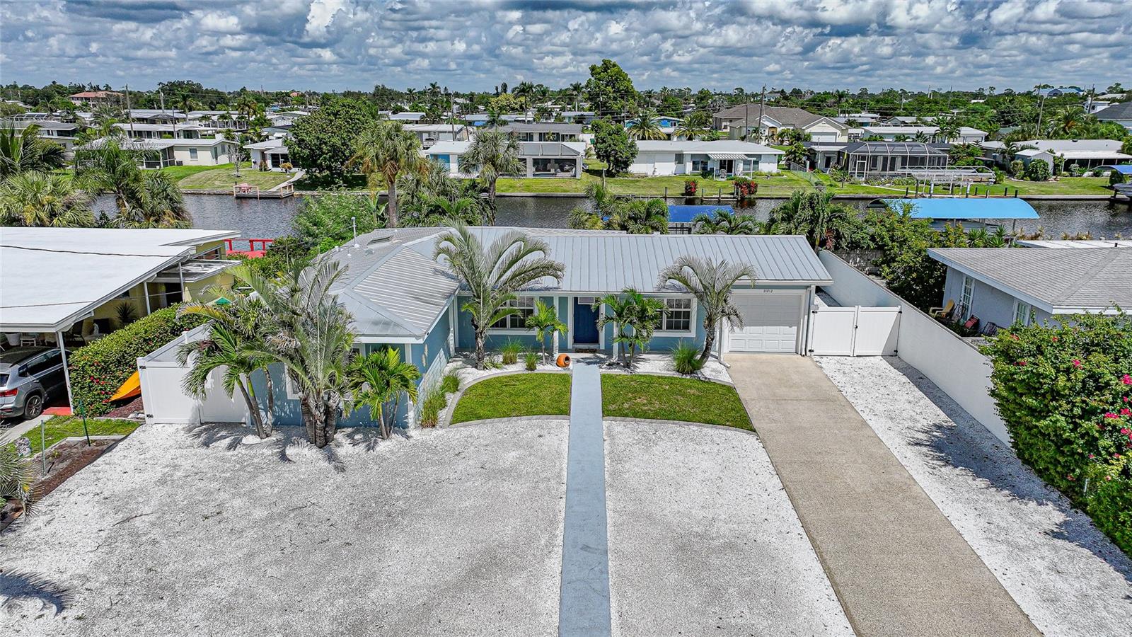 Welcome to your own slice of Florida paradise! This beautifully remodeled Key West–style, turnkey waterfront home offers 3 bedrooms, 2 bathrooms, and direct access to Charlotte Harbor—just minutes by boat to world-class fishing and boating, including Boca Grande Pass, famous for its tarpon fishing, and the Gulf of Mexico beyond.
Step inside and immediately notice the pride of ownership. The spacious open living area showcases water views, while the master suite offers a roomy walk-in closet and all-new, tastefully updated bathroom. Both bathrooms shine with stylish finishes. The kitchen has been fully upgraded with shaker-style cabinets, soft-close doors and drawers, new granite countertops, tile backsplash, and stainless steel appliances. Fresh interior paint, new doors, baseboards, and case molding pair with tile flooring throughout the home to create a crisp, coastal feel.
Updates give peace of mind, including a new electrical panel and power riser, upgraded windows, a durable metal roof, new soffit, fascia and gutters, and a new HVAC (2022). The dock features composite decking, new lift motors, aluminum lift cradles, and a new lift cover, making it ready for your boat and waterfront adventures. The property is wired for a generator and even includes a 30-amp RV hookup.
The outdoor space was designed for true Florida living. The low-maintenance yard includes shell rock in front, while the private backyard oasis offers your own sandy beach with fire pit, tropical landscaping, privacy fencing, and a dock with underwater lighting to enjoy the snook at night.
Perfectly located in the heart of Port Charlotte, you’ll have easy access to shopping, dining, beaches, golf, hospitals, and Sunseeker Resort—just 1.7 miles away. A quick trip over the Barron Collier Bridge takes you to downtown Punta Gorda and Fishermen’s Village for waterfront dining and entertainment.
Whether it’s watching the sunset from your dock, relaxing with your toes in the sand, or exploring Charlotte Harbor by boat, this move-in ready home captures everything Florida living is all about. With countless upgrades including new lighting and fans (2025), new blinds (2025), shiplap-style stucco exterior (2023), and a transferable Sentricon termite protection guarantee, this property is a rare find.
Call today for your private showing and start living the waterfront lifestyle you’ve been dreaming of.