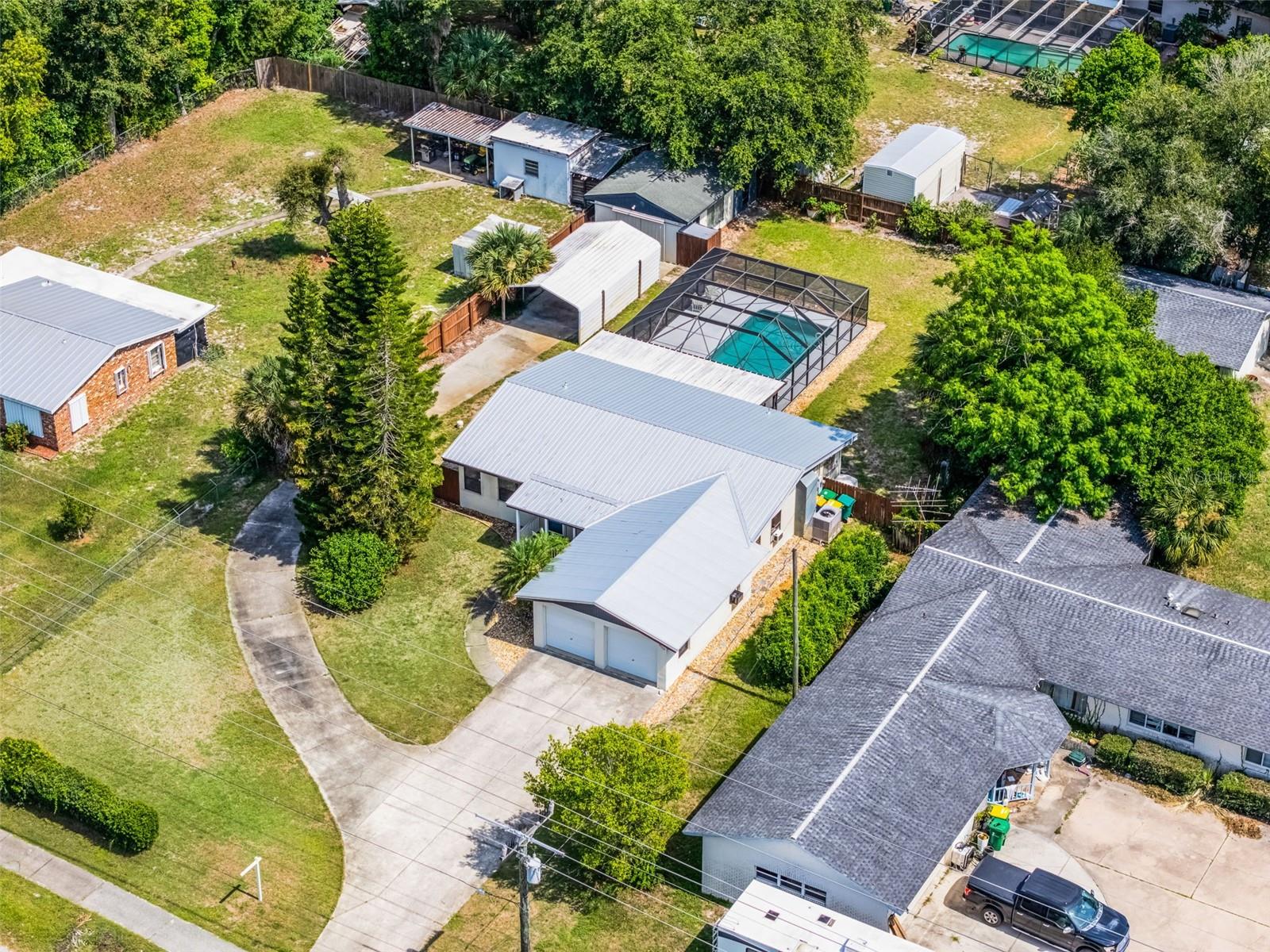 Contract fell thru do to no fault of the seller. Buyers loss your gain!!! Welcome to this charming 3-bedroom, 1-bathroom pool home situated on an oversized lot with stand out features throughout! A covered front porch invites you into a welcoming entry with a custom drop zone and built-in cabinets, leading into a cozy living room with views of the screened-in pool through elegant French doors. The spacious kitchen offers pull-out drawers for convenience, and the split-bedroom layout provides privacy—perfect for converting the master into a full en-suite, with a shower and sink already in place.
The home features beautiful wood and tile flooring, crown molding, and stunning tongue-and-groove ceilings in much of the living space. Enjoy outdoor living with a large screened pool, expansive covered deck, and a 2023 metal roof for added durability. A side gate opens to extra parking and a hurricane-reinforced large carport, plus a shed and workshop with ample space for storage, hobbies, or projects. There’s even room for your boat or trailer!
The location can’t be beat—just minutes from I-95, offering easy access to commuting.
This is a truly unique property offering comfort, character, and flexibility—don’t miss your chance to see it!