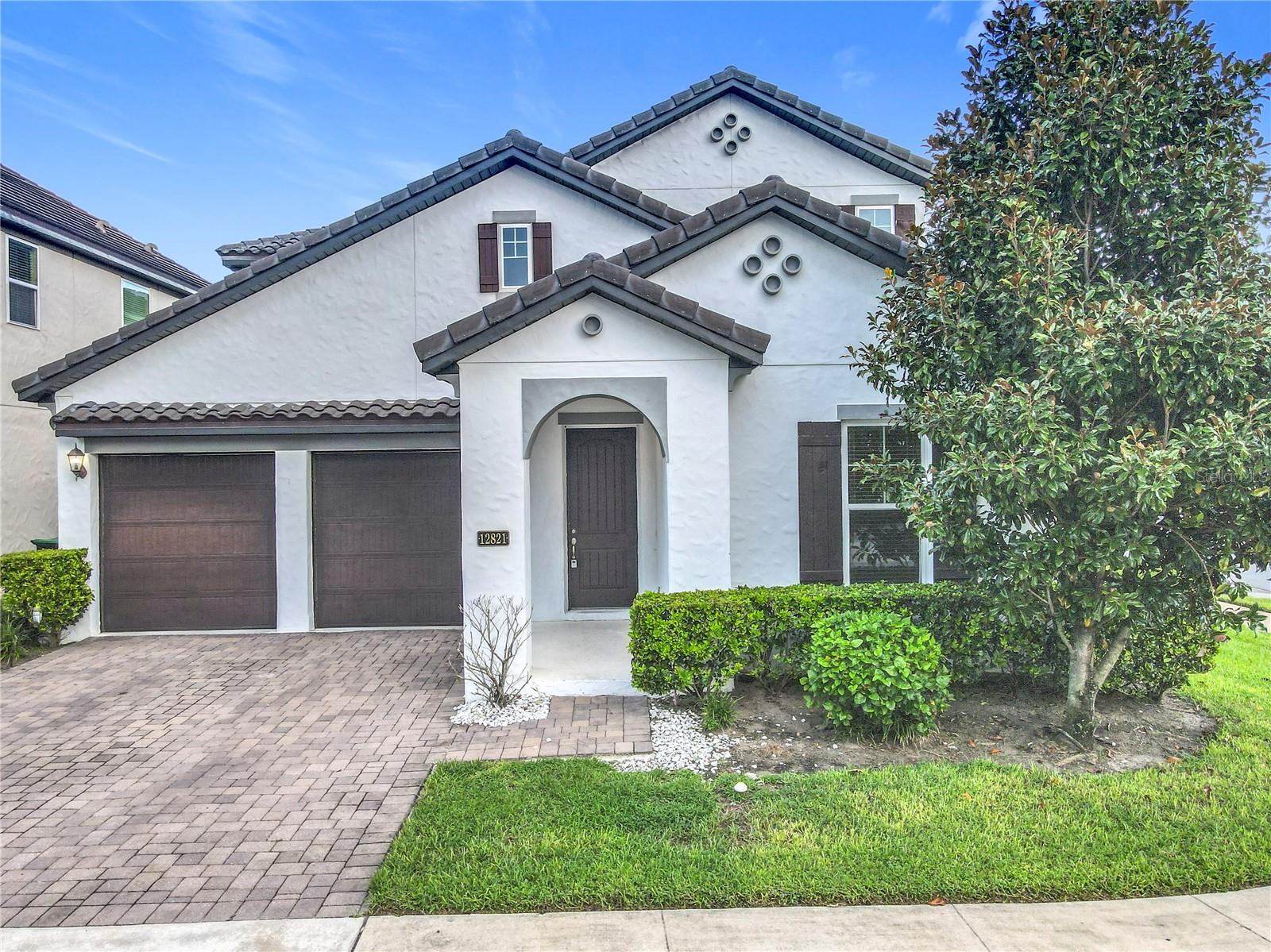 This stunning home sits on a corner 5 bedrooms plus an office and huge bonus room. once you into the large foyer where you will find the office with a double door entry and a guest bath. The formal dining room has a contemporary tray ceiling and leads into the butlers pantry with built in cabinetry and a large walk in pantry. The open concept kitchen features stainless steel appliances, granite countertops, an oversized island with counter height breakfast bar, dinette space, and sliding glass door access from both the kitchen and family room to the lanai and f yard where you can relax and enjoy the l views. The owners suite is conveniently located on the main floor. The en-suite bath boasts a double sink vanity with granite countertops, a garden tub, and glass enclosed shower as well as a very large walk in closet. The remaining 4 bedrooms are upstairs and are connected by Jack and Jill bathrooms; each with their own vanity and walk in closet. The oversized bonus room would make a great game room and is perfect for hanging out with family and friends. Community amenities include a pool, clubhouse, and playground. Located in Windermere, minutes from great schools, shopping, and local restaurants.