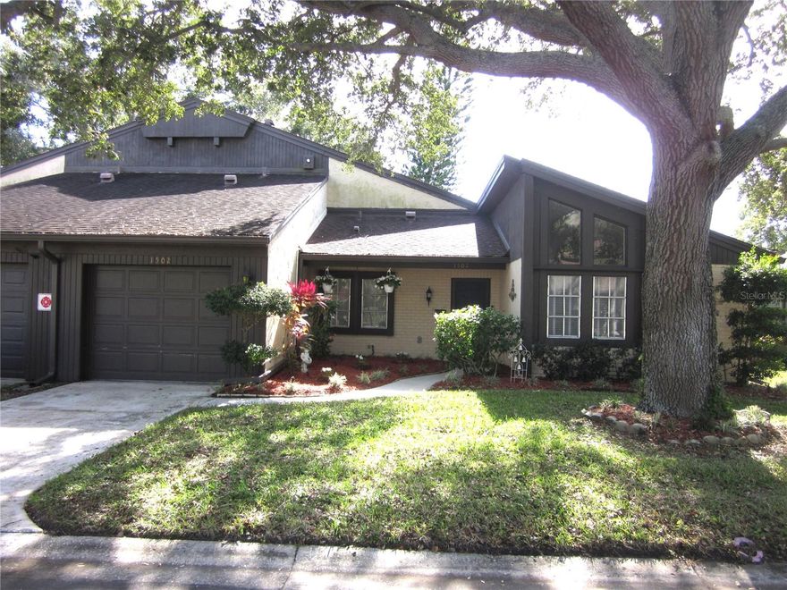 Spacious two story END UNIT villa with TWO large primary bedrooms, each with its own bath, one on the first level and one upstairs.  Located in the beautiful 55+ community of Raintree Village, a park-like setting with mature oaks and manicured landscaping.  Featuring a newer A/C system (2024), a $5K security system, and front & back yard irrigation system, comfortably sized bedrooms & large open living areas.  The open floor plan and soaring vaulted ceilings add to the spacious feel of this well cared for property. The front bonus/flex room with newer laminate flooring can be used as a den/home office/additional living room, or possible guest room/easy 3rd bedroom if needed.  Relaxing rear patio perfect for morning coffee, or grilling.  Other features include: a one car garage; washer/dryer; upstairs balcony off upper bedroom; Plenty of storage area/closet space; Formal dining room plus a casual/eat-in kitchen/breakfast nook. Back sunroom adds additional living area with pass through from kitchen.  Community heated pool, clubhouse with kitchen, game room, patio & grills, saunas, shuffleboard & more.  Convenient to nearby shopping, restaurants, medical facilities, and nearby golf course & entertainment venues. Monthly fees cover: great cable package; internet; water; sewer; trash; roof; exterior insurance; pool; common areas; and ground maintenance.  Located in a non flood, non-evacuation zone in mid-Pinellas, within 15 minutes to the sparkling Gulf Beaches! Short drive to Tampa International Airport or St. Peter-Clearwater International (PIE).  Enjoy Florida maintenance free living at its best! Sold "As Is, with right to inspect".  *See photos & virtual tour!