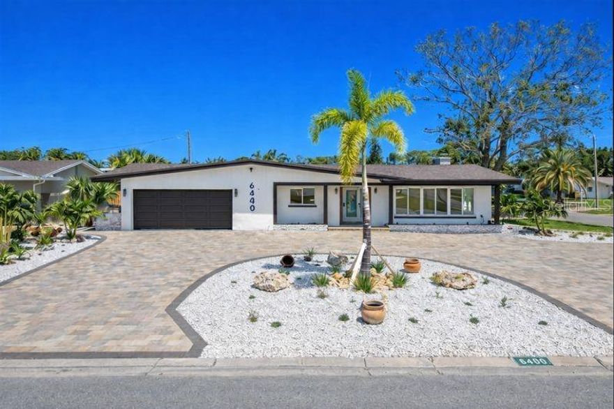 One or more photo(s) has been virtually staged. Welcome to a beautifully redesigned luxury retreat in the highly desirable Pasadena Golf Club Estates, offering refined comfort and timeless style. This comprehensively renovated home, enhanced with curated designer elements & upscale finishes, boasts 4 bedrooms & 2.5 bathrooms.  This pool home enjoys tranquil views of the Pasadena Yacht & Country Club golf course, brand-new circular paver driveway, professionally finished shell landscaping, & a light-filled interior featuring double-pane windows with plantation shutters & a distinguished wood burning fireplace in the living room. The primary suite bedroom offers a spacious ensuite bathroom with a large walk-in shower, soaking tub, dual vanities, & LED mirrors, while two additional bedrooms share a well-appointed Jack-and-Jill bathroom with beautiful marble flooring. Recent updates include new electrical wiring, raised HVAC with insulation, an owned solar system, tankless water heater, and a roof installed in 2025. The home is complemented by a private screened pool enclosure, exterior security lights, interior smoke detectors & a cooled laundry room provides added convenience.  Ideally positioned in unincorporated Pinellas County, the home provides seamless connectivity to I-275, airports, world-class beaches, exceptional dining, boutique shopping, reputable schools & local houses of worship.  Optional transferable flood insurance included.  All measurements, permitting, rental regulations & listing details are deemed reliable but should be independently verified by the buyer(s).