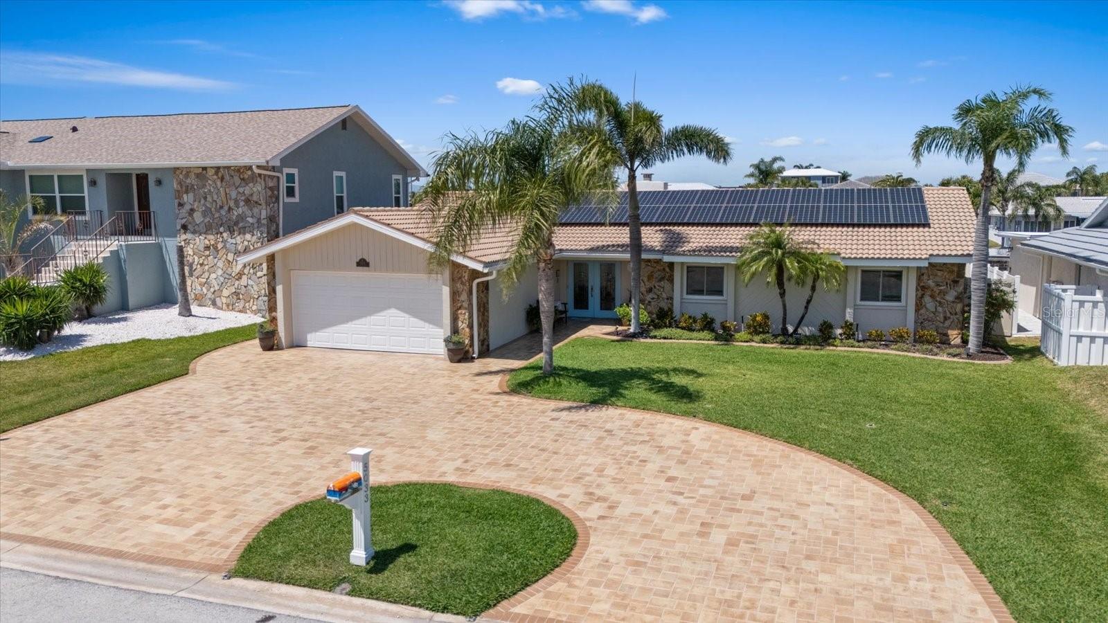 MOTIVATED SELLERS-BRING OFFER! Don't miss this opportunity to make this pristine, luxury waterfront home with all the bells and whistles your own!! Enjoy a $39/month Electric bill with PAID OFF Solar panels included at 5033 Cabrilla Ct, nestled in sunny Gulf Harbors, Florida—where every day feels like a vacation. This beautifully updated 3-bed, 2-bath, 2-car garage pool home has 1,974 sq. ft. of stylish living space and is practically brand new with top-to-bottom upgrades. It’s perfectly set on a deep water canal with quick, direct access to the open Gulf—just minutes away! You’ll love having your boats right in your own backyard, with 70 feet of seawall that can accommodate a large vessel up to nearly 60 feet. Enjoy the convenience of a 10,000 lb. electric boat lift installed in 2023, along with two fixed docks for added functionality. The huge pavered driveway welcomes you home and provides ample parking for family and guests. Inside, the living room stuns with vaulted ceilings, water views and a cozy electric/wood-burning fireplace. The kitchen is a showstopper with soft-close wood cabinets, beautiful countertops, and sleek LG “no fingerprints” stainless steel appliances. Other highlights include crown molding, plantation shutters and massive walk-in closet in the primary suite, along with a handicap-accessible ensuite bath with a tall toilet and grab bars. Recent updates include All Hurricane-rated doors and windows, New A/C condenser, New Water softener, New Pool pump, Fresh interior paint, Gorgeous LVT flooring throughout, Solid wood interior doors, New double vanity in the primary bath, and a New single vanity in the second bath. There’s even an INDOOR LAUNDRY ROOM off the garage with a large-capacity washer and dryer with sink cabinet. Out back, enjoy the large pavered walkways and deck surrounding your saltwater pool with a brand-new pump and an updated hot tub featuring new motors (2025). The stylish PVC fencing with stainless steel cable keeps your water view wide open so you can enjoy every moment on your deck or in the pool or hot tub. This one of a kind home also features a screened in lanai perfect for al-fresco dining in any weather! The whole-house solar system is fully paid off, so you'll love the low electric bills—and yes, it stays with the house! Want to save even more? Ask about the transferable flood insurance policy—just $3,593/year. Bonus perks: Optional Gulf Harbors Civic Association membership provides a monthly newsletter, events, and rental discounts at just $125/year, Optional access to our private beach club offering white sand shores, cabanas, BBQs, and spectacular sunsets for just $200/year. All this, in a golf cart-friendly community, just minutes from downtown New Port Richey, Sims Park, shopping, and the Gulf Harbors Yacht Club. This immaculate, move-in-ready home truly has it all—don’t wait! Schedule your tour today and start living your waterfront dream.