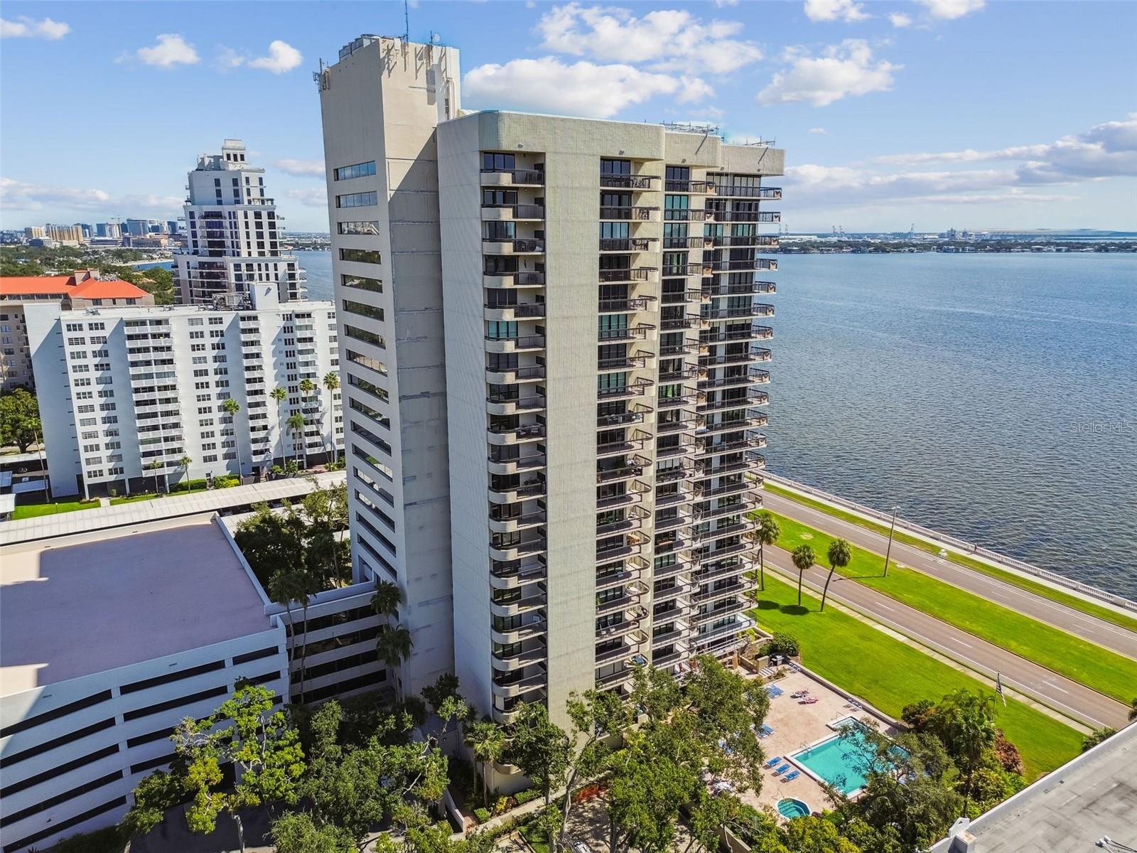 Experience elegant living high above Bayshore Boulevard in this beautifully appointed two-bedroom, two-bath residence located on the 20th floor. With 1,520 square feet of living space, this home offers an open floor plan filled with natural light and sweeping views of Bayshore Boulevard and Hillsborough Bay. Designed with a Tuscan-inspired aesthetic, the kitchen features granite countertops, wood cabinetry, a center island, and a seamless flow into the dining and living areas—perfect for entertaining or relaxing while enjoying the view. Stone flooring runs throughout the main living spaces, complemented by Berber-style carpet in the bedrooms. The spacious primary suite includes an ensuite bathroom and a generous closet, while the second bedroom—with custom wood built-ins and a desk—offers a perfect space for an office or guest room. A washer and dryer are conveniently included in the unit. Residents enjoy two assigned parking spaces in the secured garage and resort-style amenities including a pool and spa overlooking Bayshore Boulevard, a fitness center, and a stylish club room. Enjoy luxury, comfort, and breathtaking views in one of Tampa’s most sought-after locations. Schedule your viewing today!