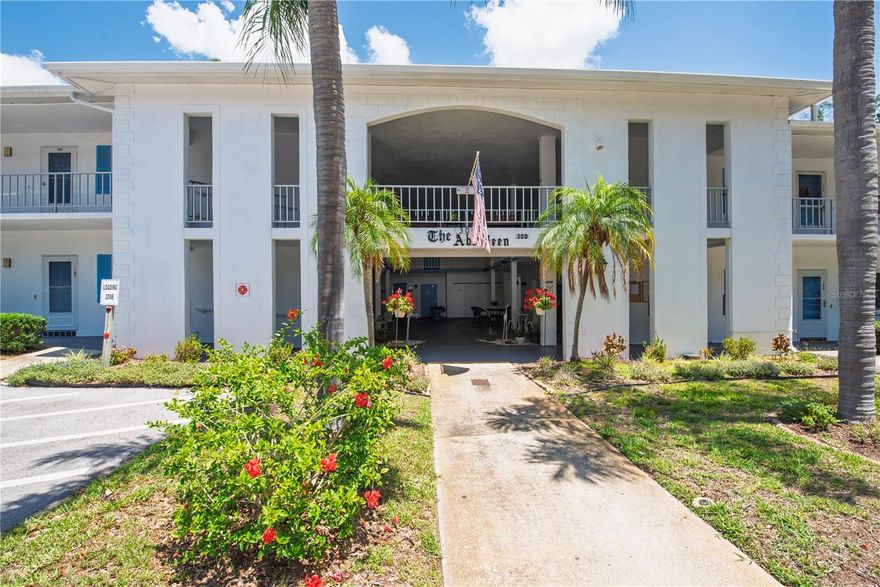 Welcome to your slice of sunny Dunedin paradise — where mornings on the Pinellas Trail, beach days at Honeymoon Island, and dinner downtown are all practically in your backyard. Tucked inside a charming 55+ community, this beautifully updated first floor condo is serving easy living with a fresh 2026 update that buyers are going to obsess over. 

Inside, you’ll find brand new engineered wood plank flooring flowing throughout, a crisp white kitchen with soft-close, fir wood cabinets and quartz countertops that looks straight out of a design magazine, and a bathroom refresh featuring gorgeous new shower tile and quartz surfaces — all completed in 2026. It’s bright, clean, coastal, freshly painted (2024) and move-in ready without the “I need to renovate this immediately” stress. The enclosed porch is the hidden gem here. With sliding glass windows and direct access to the green space behind the unit, it feels like your own peaceful little garden retreat — perfect for morning coffee, plant babies, bird watching, or pretending you’re retired even if you’re not fully there yet. There's also a large, walk-in closet off the enclosed porch for all your storage needs. Offered turn-key (minus the living room couch and area rug), this condo is ready for seasonal escapes, year-round living, or your “I’m done mowing lawns forever” era. 

Additional peace of mind includes HVAC (2017 - seller says routinely serviced) and water heater (2025). And the location? Well, the Clubhouse has billiards, library, exercise machines, and heated pool. Outside, you'll find a covered common area and a BBQ area with picnic tables. You’re minutes from Downtown Dunedin, Mease Dunedin Hospital, grocery stores, beaches, shopping, restaurants, breweries, and some of the best sunsets Florida has to offer. No pets or leasing allowed per association rules. ESA/Service animals permitted with condo association approval. There's a strorage area for your bike and another with designated space for your belongings. This isn’t just a condo — it’s a lifestyle upgrade with less maintenance and way more margarita time.