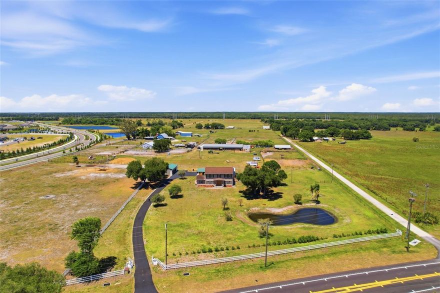 NEARLY 7 ACRES WITH NO HOA OR CDD — IDEAL FOR BUYERS NEEDING SPACE, FLEXIBILITY, AND FREEDOM TO USE THEIR PROPERTY.
Private gated estate in Parrish offering room for RVs, boats, equipment, or workshop potential — opportunities like this are becoming increasingly limited in the area. Enjoy peaceful country living with the ability to live, work, and store what you need, all while remaining close to daily conveniences and commuter routes. This well-maintained home offers 3 bedrooms, 3 bathrooms, a separate office ideal for remote work or hobbies, and 2,644 square feet of living space with generously sized bedrooms, including two with en suite bathrooms ideal for guests or multigenerational living. Relax on the welcoming front porch overlooking the pond, or enjoy the screened lanai with private pool and spa, perfect for entertaining or unwinding in private surroundings. Pool resurfaced in 2020. Solar heat and pump replaced in 2019. New screening on enclosure. Separate fenced dog pen just off the lanai provides a secure space for pets. Built for both comfort and function, the property includes two oversized garages, one measuring approximately 50.3' x 24' with workshop space and attached 24' x 22' carport, and a second garage measuring approximately 40.2' x 24.4'. Covered parking for up to 10 vehicles. Enjoy the freedom to store boats, RVs, trailers, tools, hobbies, and recreational vehicles on your own property. Major improvements include roof replaced in 2019, two central AC systems with one replaced in 2019 and the other in 2024, mini split added with home addition in 2021, 80-gallon stainless steel water heater replaced in 2020, vinyl siding updated in 2018, electrical panel replaced in 2026, and water treatment system. Fully fenced agricultural-zoned property offers room for animals and flexibility to expand or add structures subject to county approval. Located in Flood Zone X. Serviced by well and septic. Properties offering this combination of acreage, privacy, functionality, and updates rarely become available in today’s market.