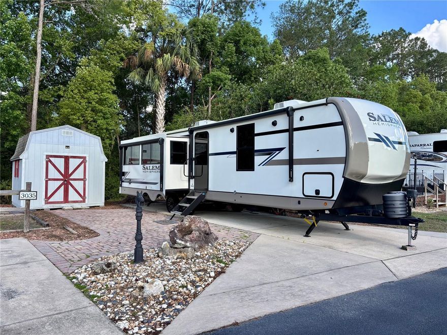 Peaceful Retreat in 55+ Wilderness RV Park – Upgraded 2024 RV Included!!
Don’t miss this rare opportunity to own an extra-wide deeded RV lot in the highly desirable Wilderness RV Park, a vibrant 55+ community in the heart of Florida’s natural beauty. This exceptional property includes a nearly-new 2024 Forest River Salem Hemisphere 308RL, a spacious and upgraded 39-foot RV with three slide-outs and all the comforts of home.
The RV has been used only three times and is in like-new condition. It features a king-size bed with generous storage throughout. The interior is light and bright with a kitchen island and pantry, modern finishes, and an open, welcoming layout designed for comfort and convenience.
The lot is extra wide, offering additional space and flexibility. It backs up to wooded conservation land, providing peace, privacy, and a natural setting. A shed is included for extra storage. Best of all, this is a deeded lot—you own the land, with no land lease required.
Wilderness RV Park offers a wealth of amenities, including a clubhouse for social events and community gatherings, a heated pool and hot tub, a fitness center, and shuffleboard courts. Residents enjoy direct access to the Ocklawaha River and the Florida Greenway Trails, perfect for kayaking, fishing, hiking, and biking.
The low HOA fee covers sewer, water, trash service, private road maintenance, grounds upkeep, and full access to all community amenities, making for a low-maintenance, worry-free lifestyle.
Located just minutes from Silver Springs State Park, shopping, dining, and historic downtown Ocala, and only about an hour from Florida’s East Coast beaches, this property offers the perfect blend of comfort, nature, and convenience. Whether you're looking for a full-time residence or a seasonal escape, this upgraded RV and beautiful lot are ready for you. Schedule your showing today.