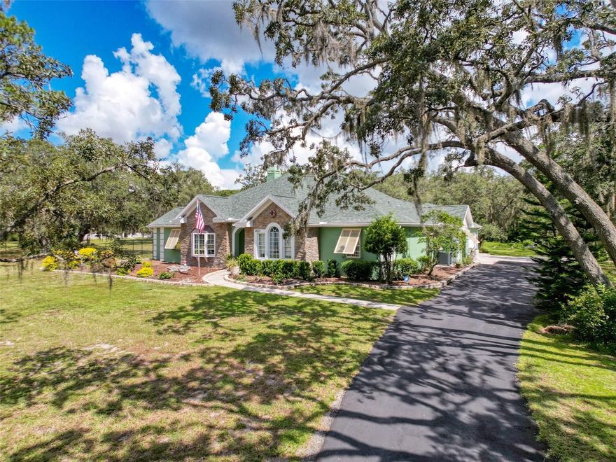 Experience Refined Country Luxury with City Convenience located in Oak Lakes Ranchettes. Indulge in the perfect fusion of elegance, comfort, and practicality in this exquisite estate, nestled on 2 acres of lush, park-like grounds. Located in a serene country setting, yet just minutes from city conveniences, this property provides the ultimate Florida lifestyle. The gourmet kitchen is a dream for culinary enthusiasts and entertainers alike. A vaulted great room creates a grand, light-filled gathering space, while the owner’s retreat boasts a walk-in closet and a spa-inspired atmosphere. Guest bedrooms are generously sized with large closets, ensuring comfort for family and friends. Step outside to your private resort-style pool, surrounded by nature for unmatched privacy. The acreage offers endless possibilities—ample parking, RV parking with 30A hookup, and plenty of space for recreation. Practical luxury abounds with a storm-resistant design, full-service backup power, oversized garage & workshop, well house, and storage shed. Enjoy peace of mind with recent upgrades including a 2018 roof and 2019 AC. This property perfectly balances peaceful country living with urban accessibility—a rare opportunity for those seeking both sophistication and practicality in their next home. Assumable VA Loan