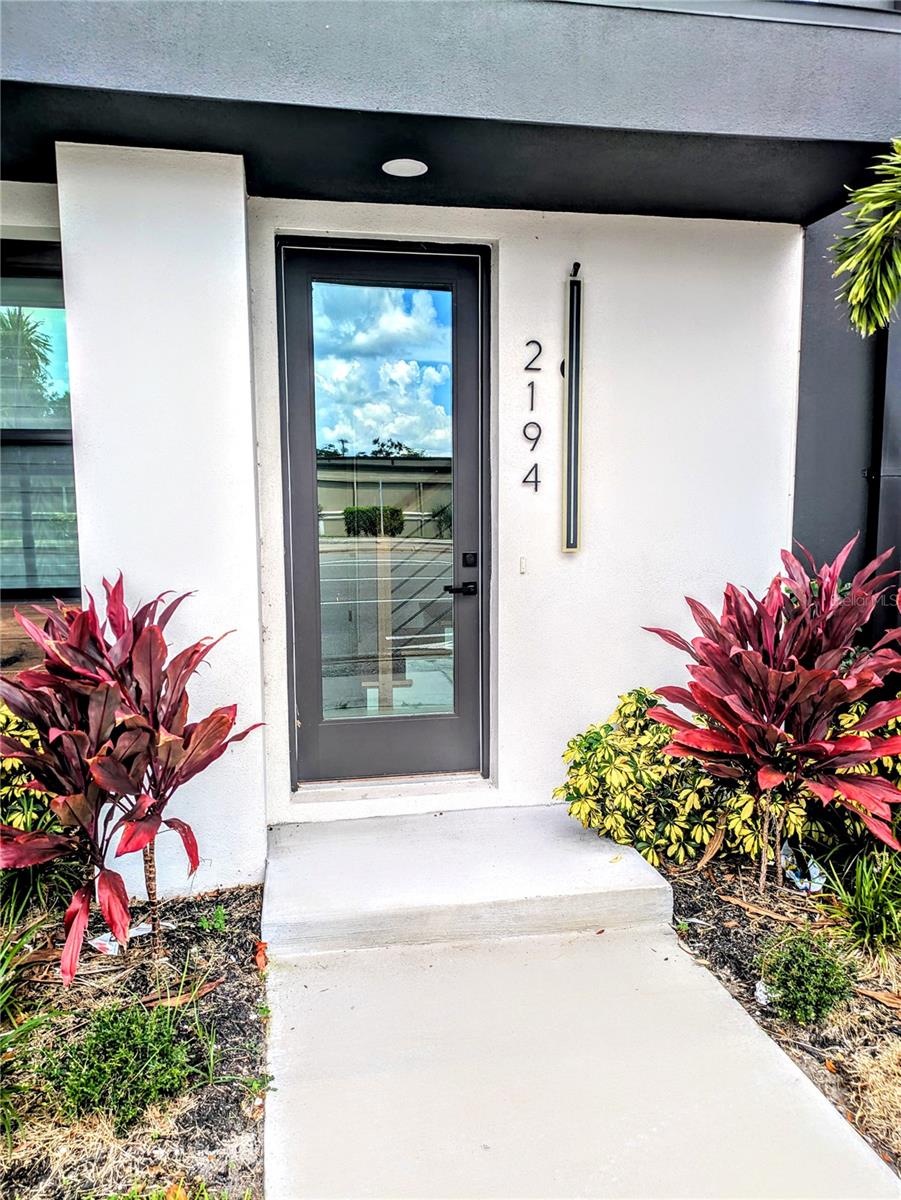 Annual unfurnished brand new construction, an amazing townhome flooded with natural light, showcasing large rooms with high-end finishes, lighting, high ceilings, and a comfortable, stylish design. Enter through the front door or access the rear 2-car garage with epoxy flooring. The entryway features a laundry area, elevator, or staircase leading to an open and exciting living area on the 2nd floor. The spacious kitchen includes a large island with a breakfast bar, waterfall quartz counters, and pendant and accent lighting. It offers loads of solid wooden cabinetry, a custom tile backsplash, and stainless steel appliances, adjacent to the dining area and great room with an electric fireplace. The next floor up holds the bedrooms. The main bedroom is spacious with an ensuite bathroom featuring dual sinks, a walk-in shower, and a big walk-in closet. The second bedroom has access to another full bathroom. The rooftop boasts an exceptional outdoor living area with an outdoor kitchen and room to spread out and enjoy the city views. You will find this location close to shopping, casual and fine dining, theater, opera, museums, library, and the beach. It's time to come home to a really special place in downtown Sarasota. This community is governed by a homeowners association, which may require an application, background screening, fees, and an approval process. Contact the agent for details. Call today!