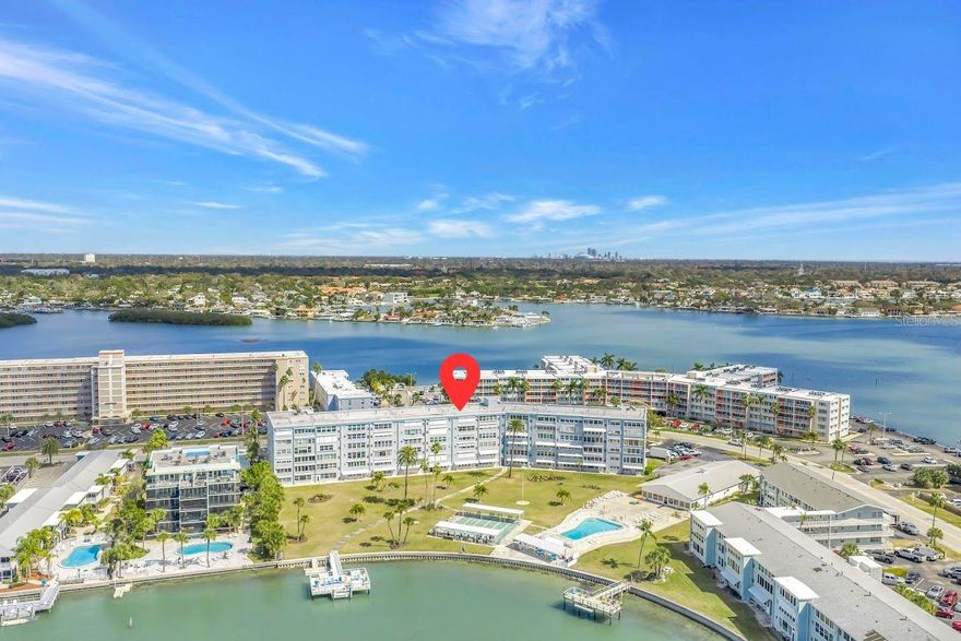 Wake up to shimmering water views every day in this beautifully updated 1-bedroom condo in the desirable Shore Towers 55+ building— perfectly positioned on the shores of Boca Ciega Bay. Bright, open, and generously sized, this residence offers peaceful living. The kitchen has been tastefully refreshed with crisp white shaker cabinetry, granite countertops, a full suite of stainless steel appliances, and a warm bamboo Roman shade that brings in just the right coastal texture. The open living area flows effortlessly, showcasing sweeping views of the bay through large windows in your Florida room — a daily reminder of why you chose waterfront living. Featuring a large primary bedroom with a walk-in closet, and a bathroom equally impressive, featuring a marble-look granite vanity, white shaker cabinetry, brushed nickel fixtures, and coastal-inspired accents that carry the breezy theme throughout. Life at Shore Towers goes well beyond your front door. The community amenities are exceptional — dive into the resort-style pool, challenge a neighbor to shuffleboard, or fire up the grills in the al fresco dining area. The private dock is a dream for fishing, kayaking, and paddleboarding, and the sunsets from the waterfront are simply unmatched. The fully equipped clubhouse features a social room with pool tables, a fitness center, and a full kitchen — everything you need for an active, connected lifestyle. Ideally located just 5 minutes from the world-renowned St. Pete Beach and 15 minutes from the vibrant energy of downtown St. Petersburg, this is Tampa Bay living at its finest — relaxed, beautiful, and right on the water.