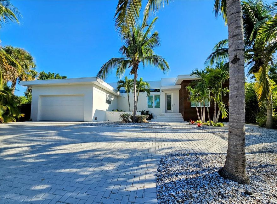 If you're looking for the perfect Florida home with modern features, premium finishes and a private pool & dock, then look no further than this very unique property nestled along Sarasota’s Phillippi Creek. This custom-made home features a contemporary design with an open floor plan and high ceilings, large windows that provide plenty of natural light and hardwood flooring throughout. The kitchen is equipped with Thermador appliances, Design-Craft cabinetry and (2) wine refrigerators. This home is powered by a 20kW solar system with 2 Tesla Powerwalls and features an EV charger as well. Most windows have electric shades installed, which can be programmed to open/close on a set schedule for convenience. The exterior features a very private, heated saltwater pool complemented by an outdoor shower, which is surrounded by a beautiful garden, palm trees and wood fencing on both sides. If you'd like to bring your boat, this home also offers a private dock with power/water supply, and a 13,000 lb lift. This home's location is extremely convenient, just under 5 miles away from downtown Sarasota, University Town Center Mall and Siesta Key.