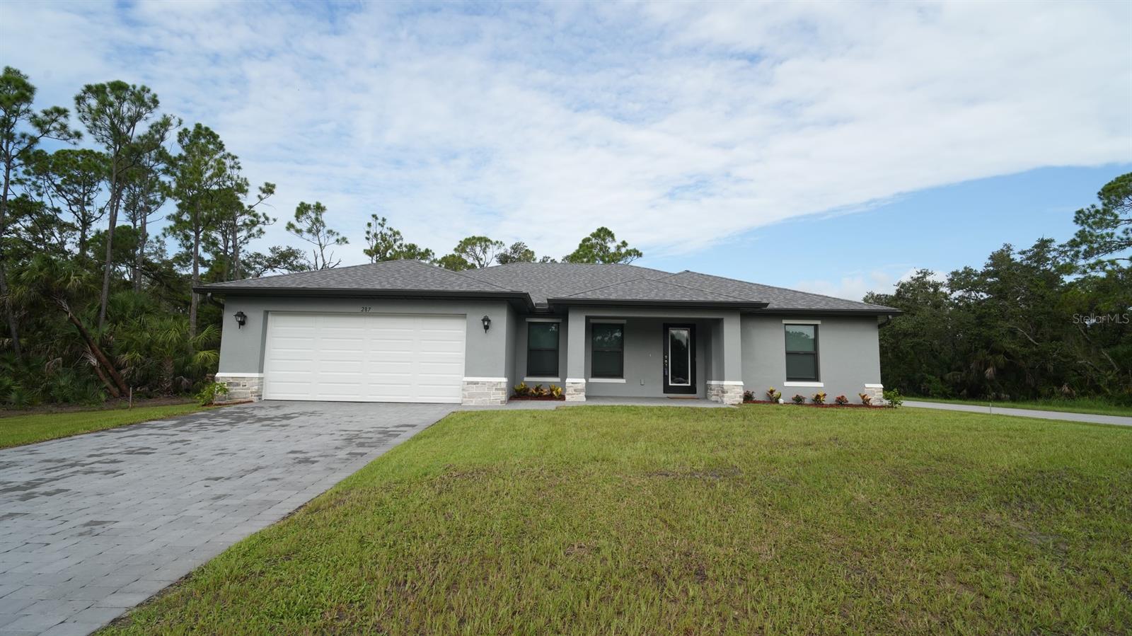 Welcome to this beautifully crafted St. Augustine model by Christopher Alan Homes on an oversized corner lot, completed in June 2025. Lightly lived in for only two months, the current owners are relocating back north—creating a rare opportunity to own a nearly new, move-in-ready home without the wait of new construction.
Designed with comfort, style, and functionality in mind, this home showcases the best of indoor and outdoor Florida living. Enjoy the charming covered front porch or relax on the spacious covered lanai, perfect for entertaining or quiet evenings. Inside, the open-concept floor plan features vaulted ceilings and a natural flow between the dining area, modern kitchen, and Great Room—anchored by a wall of sliding glass doors that fill the space with natural light.
The well-appointed kitchen includes granite countertops, stainless steel appliances, a freestanding island, and a walk-in pantry—ideal for home chefs and entertainers alike. The split-bedroom layout provides a private primary suite complete with dual walk-in closets, a dual-sink vanity, large linen closet, and a fully tiled walk-in shower.
Three additional bedrooms on the opposite side of the home offer flexible space for guests, family, a home office, or hobby room.
Notable features and upgrades include:
• Full-lite impact-resistant glass front door
• Hurricane-impact windows and doors
• Tile flooring throughout main living areas
• Built-in irrigation system for effortless lawn care
• Paver driveway
• Custom window coverings (added by current owners)
• Water softener system
• Metal roof cover installed over the A/C condenser and water softener
• Transferable new home warranty from Christopher Alan Homes, offering peace of mind for the next owner
Located in Port Charlotte, this home offers a quiet, desirable setting with no HOA and convenient access to everything the area has to offer. You're just minutes from gulf beaches, boating and fishing spots, waterfront dining, shopping centers, golf courses, and medical facilities. Whether you’re seeking a full-time residence, winter retreat, or investment property, this home offers it all.
Don’t miss your chance to own this stunning, move-in-ready home that blends modern comfort, quality construction, and a prime Southwest Florida location—schedule your private showing today!