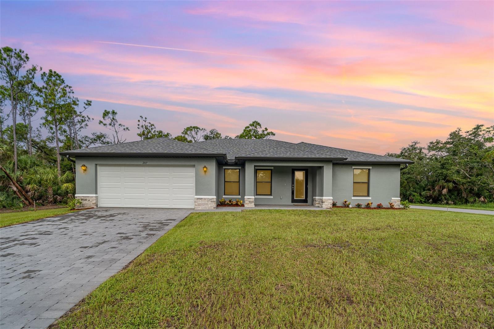 Welcome to this beautifully crafted St. Augustine model by Christopher Alan Homes on an oversized corner lot, completed in June 2025. Lightly lived in for only two months, the current owners are relocating back north—creating a rare opportunity to own a nearly new, move-in-ready home without the wait of new construction.
Designed with comfort, style, and functionality in mind, this home showcases the best of indoor and outdoor Florida living. Enjoy the charming covered front porch or relax on the spacious covered lanai, perfect for entertaining or quiet evenings. Inside, the open-concept floor plan features vaulted ceilings and a natural flow between the dining area, modern kitchen, and Great Room—anchored by a wall of sliding glass doors that fill the space with natural light.
The well-appointed kitchen includes granite countertops, stainless steel appliances, a freestanding island, and a walk-in pantry—ideal for home chefs and entertainers alike. The split-bedroom layout provides a private primary suite complete with dual walk-in closets, a dual-sink vanity, large linen closet, and a fully tiled walk-in shower.
Three additional bedrooms on the opposite side of the home offer flexible space for guests, family, a home office, or hobby room.
Notable features and upgrades include:
• Full-lite impact-resistant glass front door
• Hurricane-impact windows and doors
• Tile flooring throughout main living areas
• Built-in irrigation system for effortless lawn care
• Paver driveway
• Custom window coverings (added by current owners)
• Water softener system
• Metal roof cover installed over the A/C condenser and water softener
• Transferable new home warranty from Christopher Alan Homes, offering peace of mind for the next owner
Located in Port Charlotte, this home offers a quiet, desirable setting with no HOA and convenient access to everything the area has to offer. You're just minutes from gulf beaches, boating and fishing spots, waterfront dining, shopping centers, golf courses, and medical facilities. Whether you’re seeking a full-time residence, winter retreat, or investment property, this home offers it all.
Don’t miss your chance to own this stunning, move-in-ready home that blends modern comfort, quality construction, and a prime Southwest Florida location—schedule your private showing today!