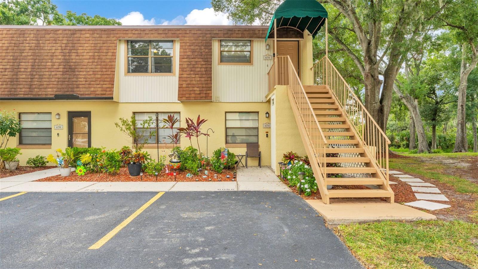 One or more photo(s) has been virtually staged. Welcome to 6056 Topher Trail, a two bedroom two bathroom condo with a fully renovated interior, located just off of Shepherd Rd and conveniently close to grocery, gas stations, dining, shopping, just miles from Publix and Walmart and so much more. This is the perfect move in ready space for your primary residence, seasonal residence or for an investment property. Walk in through the front door into the open living area which has an entryway accessing the kitchen. Enjoy walking on the sidewalk along Imperialakes Blvd for morning and afternoon strolls. The kitchen features newer and matching stainless steel appliances, with a newly installed marbled countertop to add to the kitchen's aesthetics. The window overlooks the front exterior, with a pantry for storage and barstool seating at the kitchen island. The living room is spacious for your furniture, including side tables and entertainment center, with natural lighting that filters in from the sunroom with even more living space and can also be used as a flex room for a formal dining area or office space. The view from the sunroom overlooks the water and the trees. The hallway leads towards the laundry area, where the washer and dryer remains with the sale of this condo, along with the guest bathroom, closet with the AC handler and the additional bedroom. The primary bedroom is located on the far side of the condo, with the en-suite bathroom, spacious walk-in closet, and has sliding glass doors that lead to the Florida room. The interior repaint was completed in July 2024 and water heater and kitchen countertop was entirely replaced in 2023. The luxury vinyl plank flooring, ceiling fans, kitchen appliances and AC were each installed in 2021. The on-site pool is close by and ready for your upcoming days spent in the sunshine or poolside with the BBQ. This home is move in ready to make your own, with your reserved parking space located right at the front and guest parking nearby. Schedule your tour today!