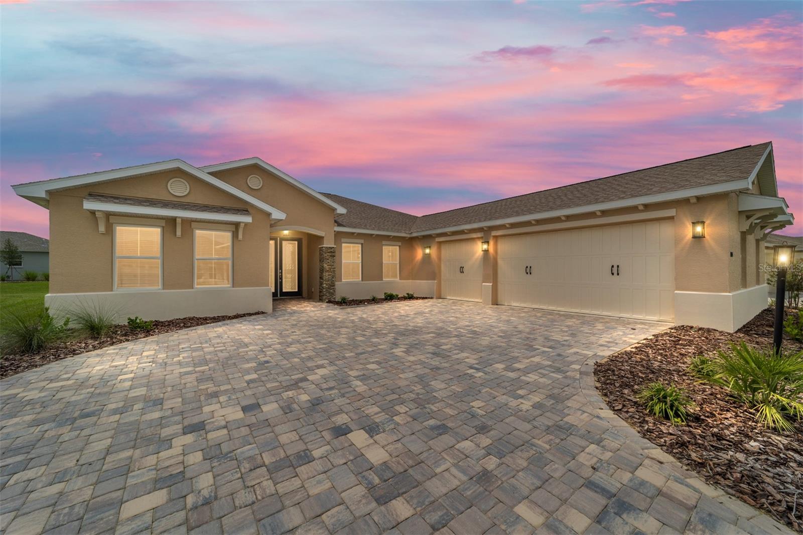 Welcome to this stunning new construction Northampton home in the sought-after Balfour neighborhood of Candler Hills at On Top of the World! From the moment you arrive, you’ll be greeted by a paver driveway, a spacious 3-car garage, and elegant French entry doors. Inside, the open floor plan features 3 bedrooms, 2 full bathrooms, and a versatile flex room with French doors, perfect for a home office or den. The gourmet kitchen is beautifully appointed with premium white staggered cabinets with crown molding, quartz countertops, a designer backsplash, under-cabinet lighting, built-in oven and microwave, 5-burner cooktop, and a pantry. The kitchen flows seamlessly into the living area, where a 4-panel sliding glass door opens to the screened lanai — ideal for indoor/outdoor entertaining. The luxurious master suite showcases a tray ceiling and a spa-like en suite bathroom with tile flooring, an oversized double vanity with quartz counters, a zero-entry tiled shower with built-in bench, and a large walk-in closet. As a resident of Candler Hills at On Top of the World, you’ll enjoy access to world-class amenities, including championship golf courses, resort-style pools, state-of-the-art fitness centers, pickleball and tennis courts, walking trails, and a wide variety of clubs and activities. All of this in Ocala’s premier active adult community! Call to schedule your private showing today!