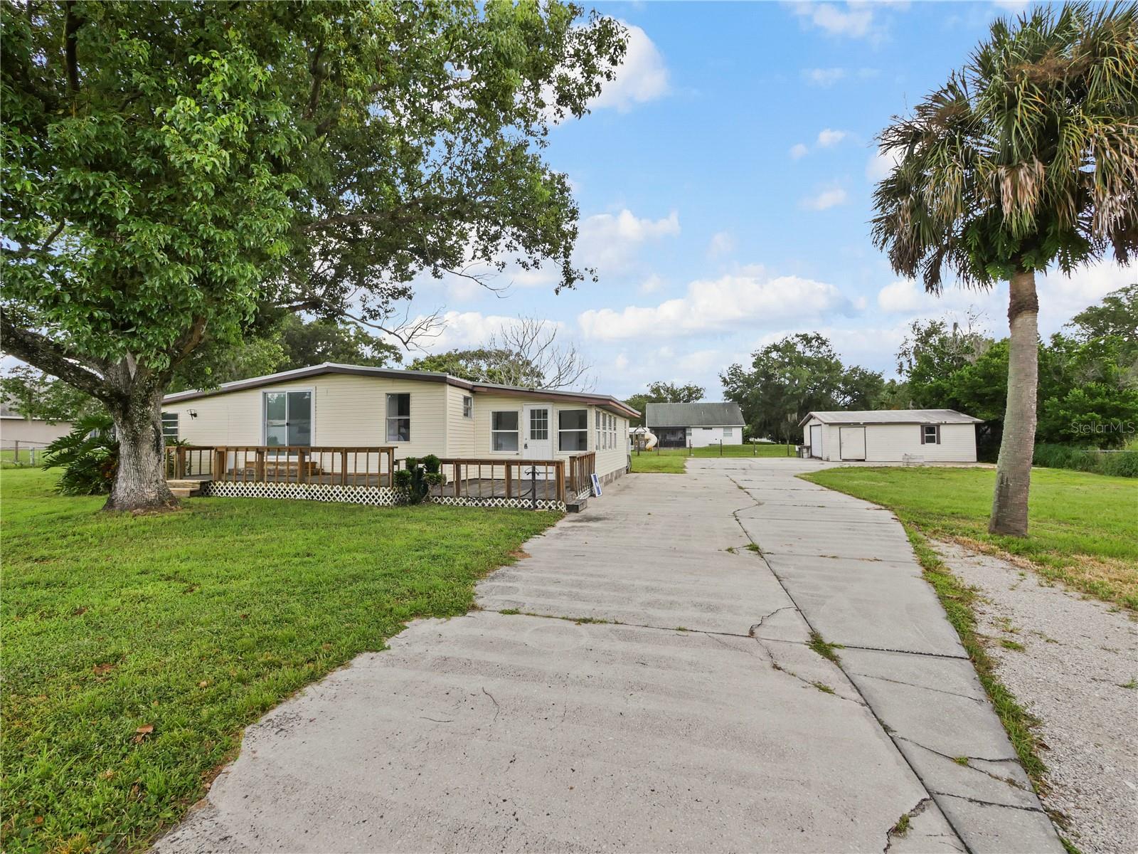 Move-In Ready on a Half-Acre Lot! This property offers Brand New LVP Flooring, an Upgraded Kitchen (2021), and a Durable Metal Roof installed in 2020. Complete New Septic System in 2017 and New Well in 2018. You’ll enjoy the Walls of Windows filling the Florida Room with Natural Light. Outdoors, enjoy a spacious deck and a cleared half-acre lot. The property is fully fenced with a wide double gate and features an extended driveway with plenty of room for an RV, boat, or trailer. A complete RV hookup with electric, water, and sewer is already in place. The large Workshop/Garage includes electric and water, perfect for projects or storage. Additional highlights include an inside laundry room, an energy-efficient commercial grade Hot Water Heater and a water filtration/softener system. Located just minutes from beautiful Avalon Park, this home combines comfort, function, and convenience.