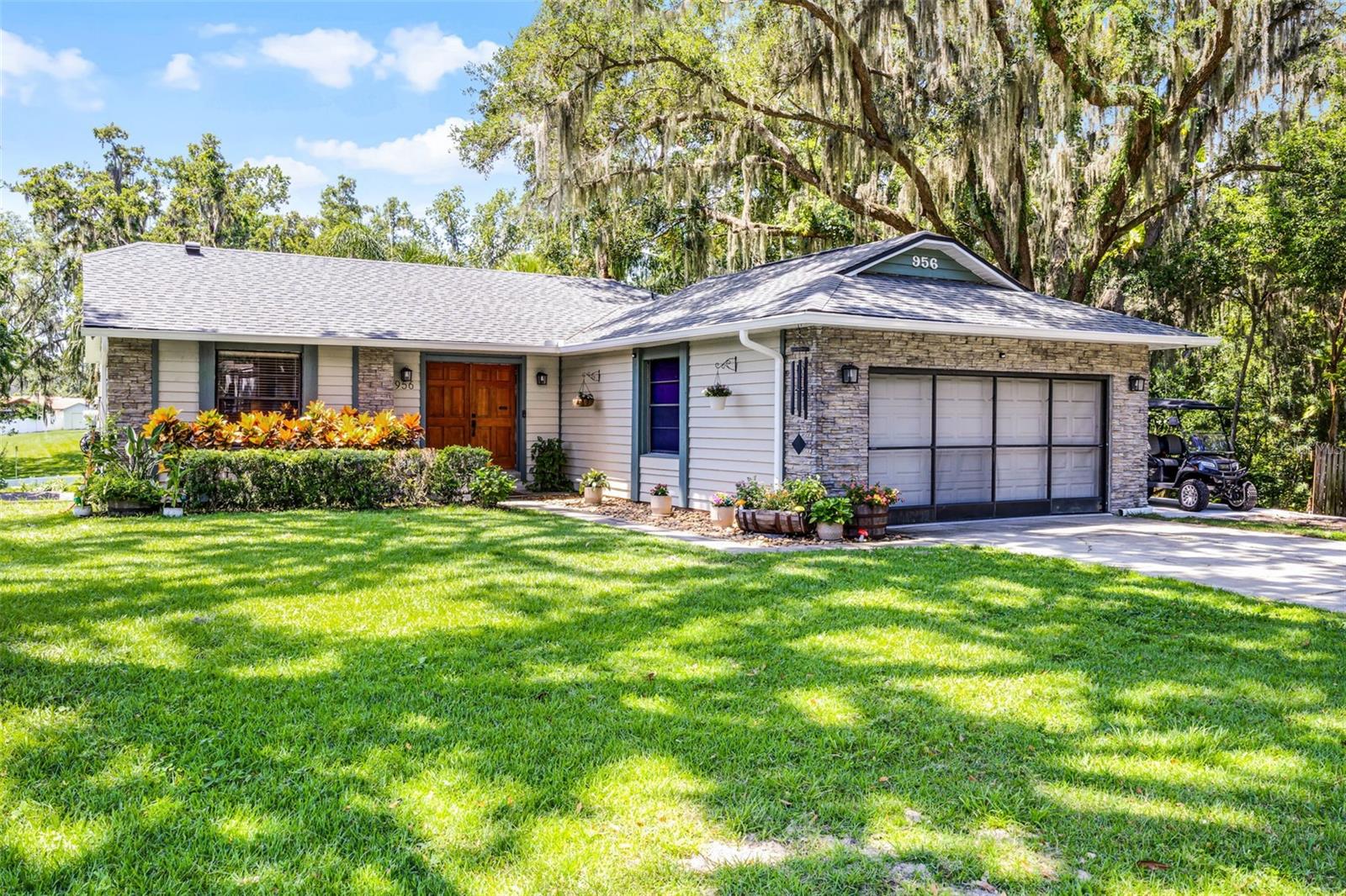 Beautifully remodeled home near Historic Downtown Winter Garden. This 2-story 4 bed / 2 bath home with a 2-car garage sits on over half an acre with a creek in the backyard on a quiet, low traffic circle. This home has so many great features including a completely remodeled kitchen (2022) a family room with a wood burning fireplace with a stone hearth and mantel, nicely remodeled hall bath, and nice neutral colors.. Other features include New A/C in 2019 ** New Water Heater ** Roof 8 years ** New Vinyl Flooring throughout ** New Garage Door Opener ** New Seamless Gutters ** Parking Extended for Boat/RV/Golf Cart ** Transferable Termite Bond. Ride your golf cart to enjoy one of the quaint restaurants in Winter Garden's popular historic district, or visit one of the many parks downtown. Enjoy no HOA in this quiet neighborhood with mature trees, so close to Lake Apopka.