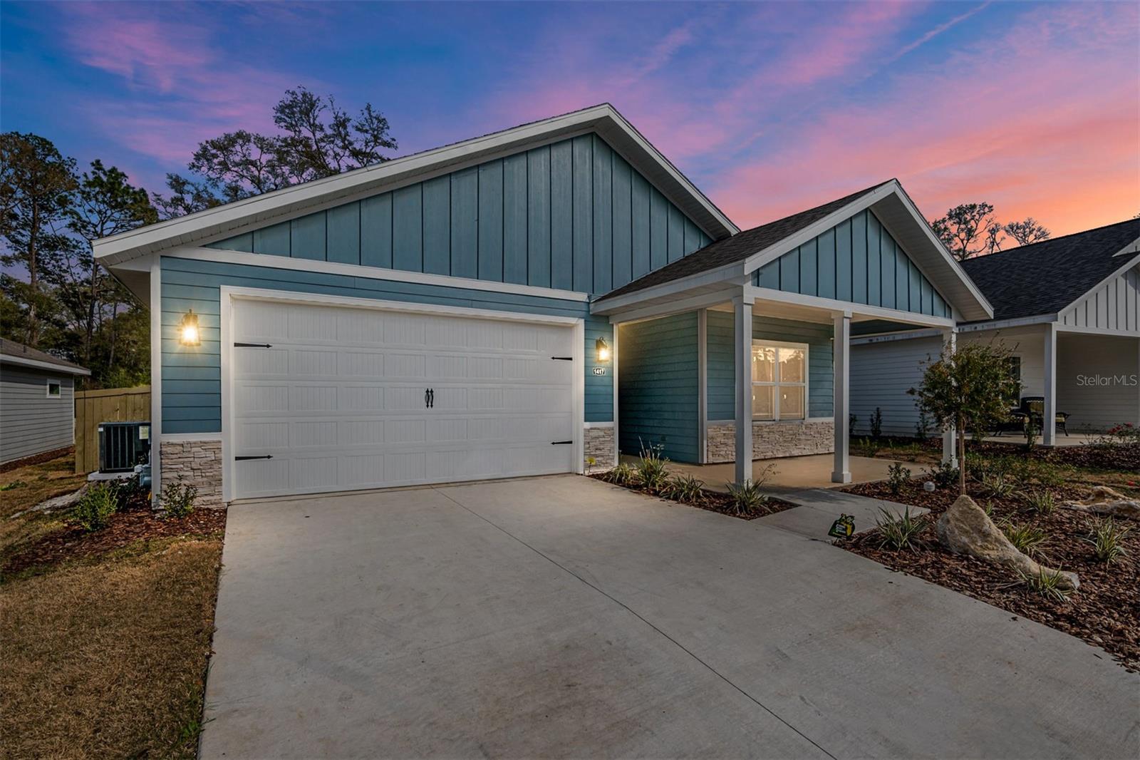 Welcome to the charming world of the=is COMPLETED Hayleigh II plan in the new and final phase 3, lot 269 brought to you by Alachua County native builder, Weseman Homes & Renovations INC. Get ready to embark on a delightful journey within the vibrant and sought-after community of Grand Oaks Subdivision. This home is a true gem, tickling your fancy with its fun & cheerful personality. With 4BR/2.5BA spread across 1766SF, it exudes just the right amount of space for your comfort and enjoyment. With craftsman style features and and the perfect corner placement next to a large open retention area, it offers privacy and extra light to stream though the unobstructed windows. Step inside and be greeted by a modern& playful design that will instantly put a smile on your face. The open layout creates a sense of togetherness, allowing you to seamlessly move from one room to another. Think competitive game nights in the living/dining room and laughter that echoes through the halls. Our finishes include commercial grade luxury vinyl floors that can endure the pitter patter of tiny feet, the tip tapping of your favorite furry animals toenails or you dancing with your honey to the beat that keeps you young and spry. No carpets here! The gas kitchen, complete with a sleek hood vent, will surely ignite your culinary creativity. Here, you can prepare delicious meals on the large central island adorned with quartz atop shaker style soft-close wood cabinets and decorative tile backsplash.The bathrooms are equally impressive, featuring luxurious quartz countertops, tile from the floors to the ceiling, decorative tile niches, and a spacious walk-in shower with not just one, but two shower heads in the main bath-providing a heavenly retreat to start or end of day. The home is not only beautiful, but built to last. Its Hardboard brand concrete siding with protective joint covers ensures durability in the hot, humid Florida weather while retaining its stylish appeal. Topping it off are architectural shingles and stunning 8’ stamped carriage house style garage doors, complete with hinges & handles to add a charming touch. Outdoor spaces are also well-designed, with covered porches ideal for enjoying your morning coffee or evening conversations.The low maintenance soffits and professionally designed front lawn landscaping, featuring easy care zoysia grass, enhance the home’s overall curb appeal. And let’s not forget the smart features that make this home cutting edge. With a smart panel and one downloadable app that controls the thermostat, garage door, keyless entry lock, and doorbell with video camera, you can easily stay connected and enhance the security of your new residence. The panel and app allow for you to add on and structure how smart you want your home to be. Location-wise, Grand Oaks is nestled near UF, 2 top ranked hospitals, Celebration Pointe and Butler Plaza. But what really sets it apart is its proximity to nature hotspots. Gainesville, a nature lover’s paradise, offers easy access to the Archer Braid Trail, Sweetwater Wetlands, Paynes Prairie Preserve and even Cedar key. So whether you are a hiker, cyclist, bird-watcher, boater, or simply like the great outdoors, tis home’s location is perfect for you. This home is perfect for your new abode or can make an incredible rental investment. Buy this home with no money down. Just ask us how!
