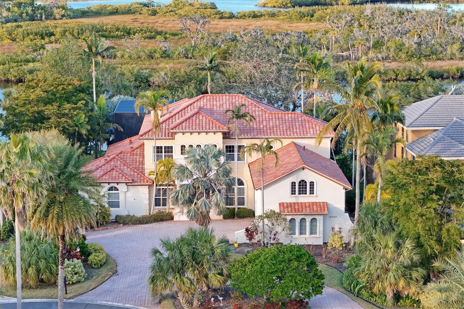 Experience the exclusive lifestyle offered by The Shores at Waterlefe, where just 28 lucky residents call this paradise...home—14 of them are Riverfront gems, including this magnificent estate!
Step into luxury with a new roof, new pool cage, and fresh exterior paint in this “gated community within a gated community.” The Shores is Manatee County’s best-kept secret for those seeking privacy, golf, and the serenity of waterfront living.
Your private composite dock, equipped with a lift for your boat and jet ski, is ready to enhance your aquatic adventures. Cast a line right from your backyard and reel in a prized catch, including snook, trout, or redfish. Enjoy the breathtaking sight of playful manatees and dolphins that call these waters home. Take a quick boat ride to nearby riverfront restaurants or cruise westward to the renowned Anna Maria Island with its stunning quartz sand beaches.
Inside your elegant estate, the newly repainted interior features timeless Travertine floors that exude sophistication. The expansive kitchen is a chef’s dream, festuring a Dacor Range, Sub Zero Refrigerator, stone countertops, and an impressive vent hood—perfect for entertaining guests! The newly refinished pool and spa, along with a modern two-story pool cage, redefine outdoor living, while the covered outdoor kitchen sets the stage for al fresco dining with friends and family.
Rest easy knowing a newer generator has been installed for your peace of mind. The upper level features luxurious LVP flooring, transforming this estate into a true multi-generational living opportunity. A kitchenette just off the Great Room, along with a balcony offering panoramic views, provides family and guests with their own space to thrive. Gather everyone in the spacious game room, equipped with a pool table and second bar, perfect for card games and memorable evenings. With an additional office space on the second floor and three comfortable bedrooms, there’s ample room for everyone!
At Waterlefe, you’re not just buying a home; you’re joining a vibrant community filled with social options centered around the newly updated River Club. Your HOA fees provide exclusive access to a restaurant, bar, fitness center, meeting space, tiki bar, and a junior Olympic pool—the social heartbeat of the neighborhood! Imagine lively gatherings with friends, daily fitness classes, card games, book clubs, and so much more filling your calendar with joy. Plus, your furry friends are welcome in this pet-friendly haven!
Optional golf club memberships and marina slips enhance your lifestyle, with the recently renovated golf clubhouse receiving rave reviews and extended hours. Premium cable TV, Wi-Fi, and internet are included in your HOA fees, offering convenience at your fingertips.
Don’t miss the chance to view this extraordinary estate with its new roof—you’ll immediately understand why it’s destined to be your dream home at The Shores at Waterlefe. Luxury living awaits, with a boat and a jet ski available through a separate bill of sale. Come and immerse yourself in this unparalleled lifestyle!