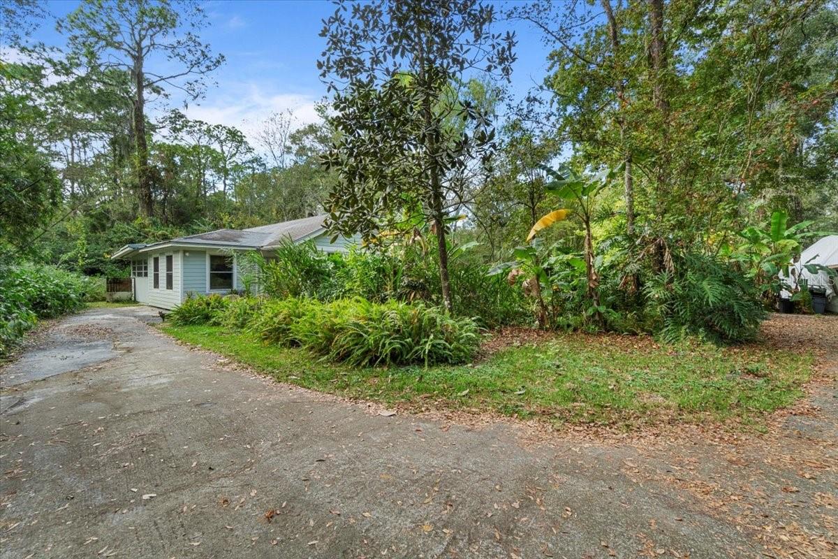 This is a single family home despite what public records say, please call for details! Welcome to the epitome of country living on this expansive property that spans over 2 acres across two parcels, providing you with a serene and spacious retreat. This unique residence began its journey as a mobile home, evolving into a charming single family home that seamlessly blends rustic allure with modern comforts. Nestled within the embrace of nature, this home boasts three bedrooms and two bathrooms, ensuring ample space for relaxation and privacy. Step into the heart of the home, where the kitchen and dining areas showcase the craftsmanship of custom-built cabinetry and woodwork, creating a warm and inviting atmosphere. The attention to detail is evident, offering a touch of sophistication to these essential spaces. The property is serviced by a well, ensuring a reliable water supply for the home and the lush surroundings. The residence is adorned with newer tilt windows, allowing natural light to fill the interior and offering picturesque views of the sprawling landscape. The roof, installed in 2002, provides durability and peace of mind for years to come. While window units are available for climate control, the roof covering the entire structure ensures added protection and insulation. Immerse yourself in the tranquility of country living, where the charm of the past meets the conveniences of the present. This property is not just a home; it's a testament to a bygone era, skillfully adapted to meet the needs and desires of modern living. Welcome to your country oasis, where every corner tells a story and every acre invites you to create your own.
