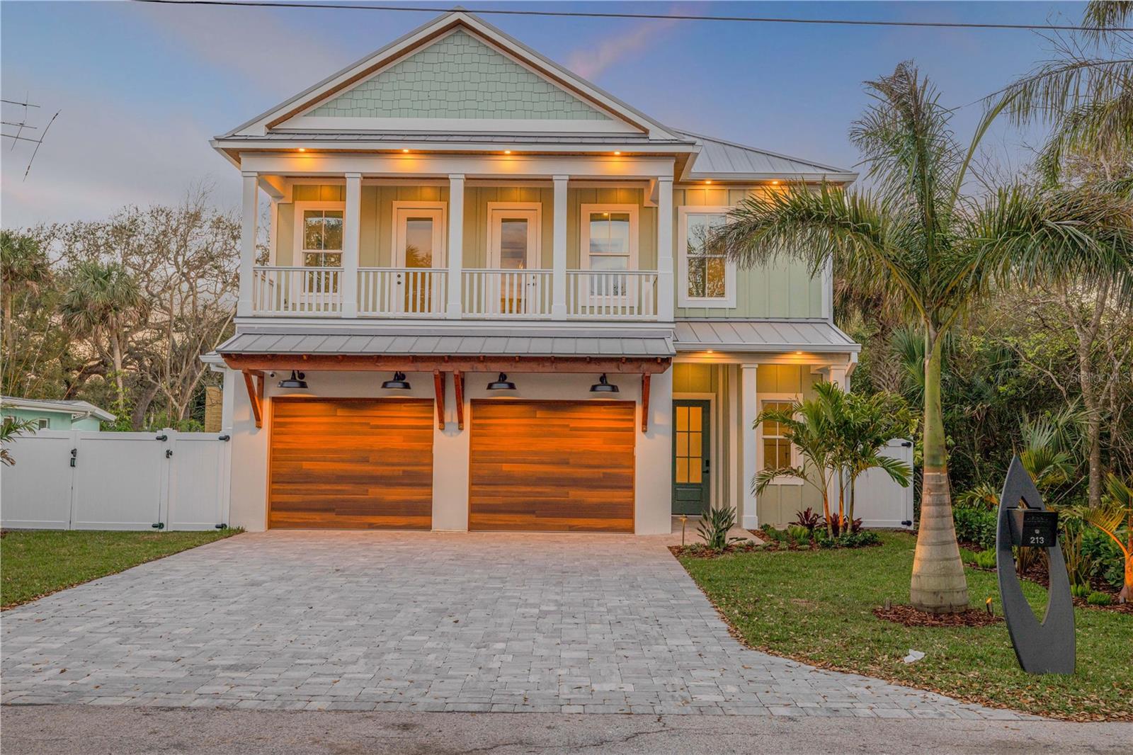 Welcome to a breathtaking year 2025 built beachside coastal masterpiece. It is located deep in the heart of New Smyrna Beach’s historic district. This two-story architectural gem harmoniously blends modern luxury with coastal charm, offering an exquisite living experience.
Spanning five bedrooms, three bathrooms, and a versatile office/bonus room, this stunning home serves as a true sanctuary of sophistication. The open-concept design is adorned with wide-plank white oak, marble, and porcelain tile flooring, complemented by a custom oak staircase and striking quartzite countertops featuring a four-inch thickened edge. The chef’s kitchen is a culinary dream, equipped with top-of-the-line Thermador appliances, including a 42” range, a three-tower fridge/freezer system, wine cooler, under-counter microwave, and a white quartzite waterfall center island.
The luxurious primary suite is a spa-inspired retreat that features a double vanity, deep soaking tub, steam shower, and high-end finishes, creating the perfect escape. High vaulted beamed ceilings enhance the spacious ambiance, while premium impact-rated windows and doors flood the home with natural light. A cozy fireplace adds warmth and charm to the interior. Designed for modern convenience, this fully automated home includes a whole-home generator, a custom-made state-of-the-art audio-visual package, and smart lighting that allows you to customize your environment at the touch of a button.
Step outside to your personal paradise. The designer pool, featuring a sleek black finish, an 8-person spa with a cocktail bench, integrated amber-lit lighting, and a self-cleaning system, is framed by expansive decking for ultimate relaxation and entertainment. The gourmet outdoor kitchen is perfect for alfresco dining, equipped with premium appliances to elevate your outdoor culinary experiences. Enjoy a spacious covered balcony and dual front and back porches that enhance the coastal Florida lifestyle. A custom-made surfboard mailbox adds a signature touch to the property. The epoxy-finished garage offers a sleek, durable space for vehicles and storage.
Located just two blocks to Flagler Avenue, you’re steps away from charming boutiques, award-winning restaurants, and the pristine sandy beaches of New Smyrna Beach. Whether you seek a peaceful retreat or an entertainer’s haven, this home epitomizes elite beachside living. Indulge in perfection—schedule your private tour today and experience the pinnacle of coastal luxury living.