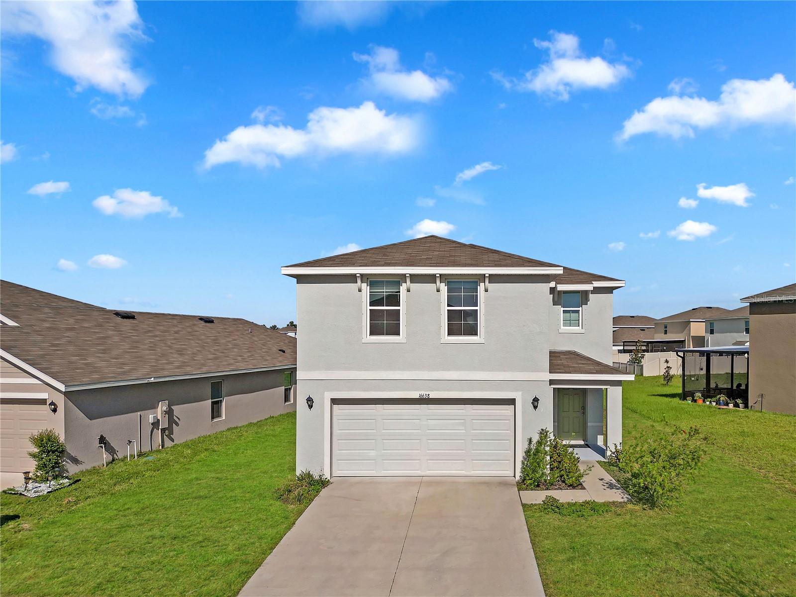 Welcome to 16638 Mosaic Oar Drive, a beautifully built 4-bedroom, 2.5-bath home located in the peaceful Sereno community of Wimauma. Constructed in 2023, this spacious two-story residence offers approximately 2,260 square feet of modern living space, featuring an open-concept layout with a bright living and dining area, stylish tile and carpet flooring, and a well-equipped kitchen with stainless steel appliances, ample cabinetry, and generous counter space. The first floor also includes a convenient half bath, while all four bedrooms and a versatile loft are located upstairs. The primary suite offers a large walk-in closet and a private ensuite bathroom, while the three additional bedrooms share a full bath with dual sinks. Situated on a 6,100+ square foot lot, the home also includes a two-car garage, concrete block construction, and a fenced backyard perfect for outdoor enjoyment. With no HOA and close proximity to schools, parks, shopping, and major highways, this home provides the ideal blend of comfort, convenience, and contemporary style.