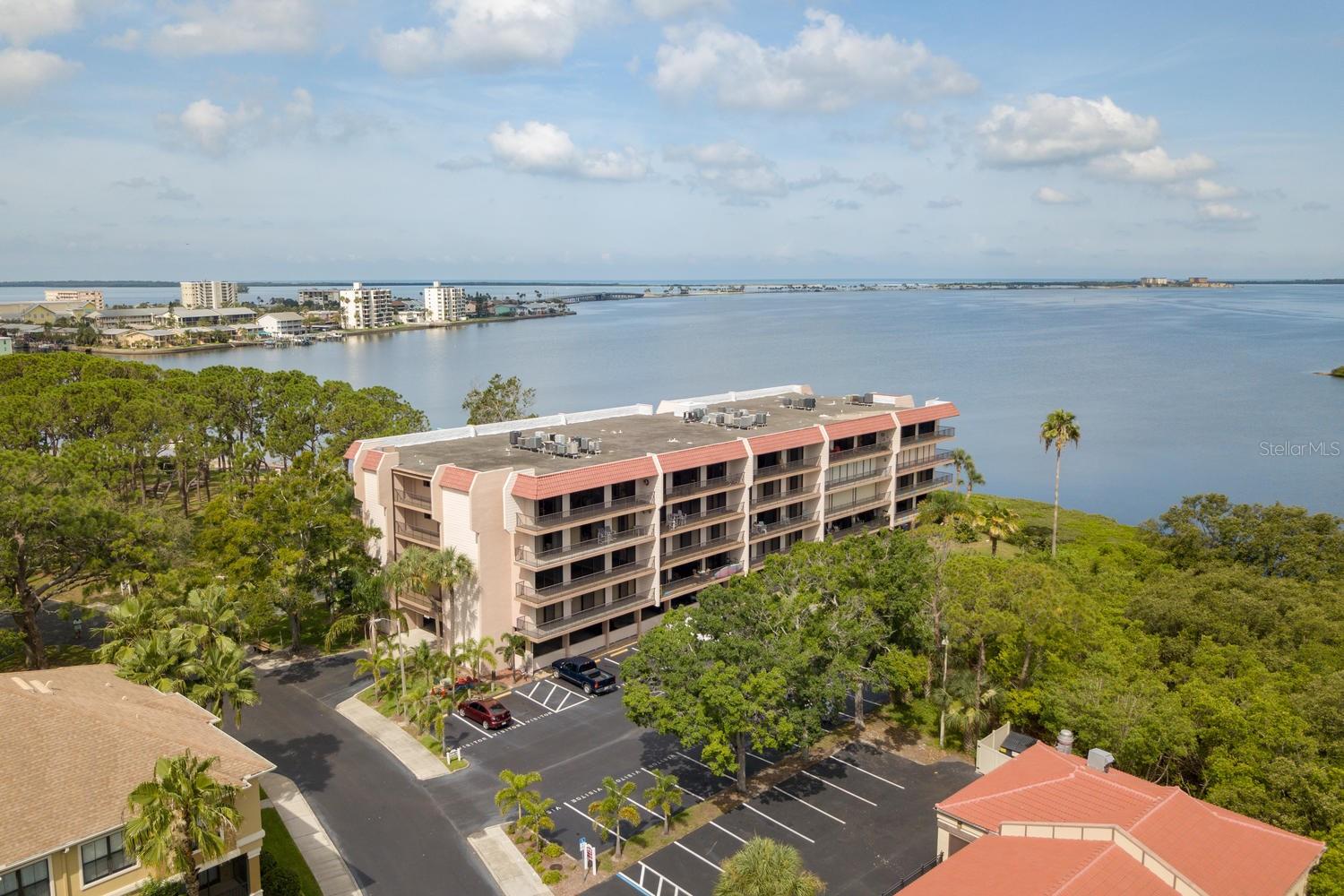 Watch the dolphins play! 2br/2ba end unit Dunedin condo with 38 foot balcony offers sunset views over the Bay, park & private beach! Tenant leaving shortly. Yearly unfurnished rental is bright and spacious, with split BR plan, lots of closets, snack-in window kitchen, big master suite with walk-in closet and step-in shower, mostly tile floors & covered parking in security building. On-site private beach, waterfront parks & clubhouse, rec building, heated pool, tennis- even place to launch your kayak! Walk to shopping & restaurants, with the Pinellas Bike Trail across the street! rent includes water, trash,cable & WiFi! yearly only, NO pets or smoking. First, last & & security. Note- DR server stays