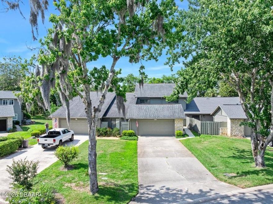 ORMOND BEAUTY!!! You will fall in love with this spacious, open floor plan with fireplace, vaulted ceilings and Florida Room. Centrally located, this 4-bedroom, 2.5 bath townhome with 2-car garage has 2,570 living sq ft and 3,126 total! Light & Bright with openness makes this 2-Story home feel even more massive!! Accented Stone Fireplace and Skylights with Natural Lighting add to the beauty. Nice Courtyard Entry is gated! Kitchen features Newer Stainless-Steel Appliances Kitchen, Breakfast Nook and Double Pantry. Master Suite on 1st floor highlights Double Vanity, 2 Closets, Shower, Tub. Exterior Paint 2024. Roof 2018. Hurricane shutter protection all the way around! W/D stay. Amenities: Gorgeous Community Pool, Club House, Tennis, Pickleball, Shuffleboard and Pond/Fountain. Cats/Dogs are welcome! Low HOA fee includes Pool, Cable, Internet, Lawn, Pest. Driveway accommodates 6 cars. Come fall in love with one of Ormond Beach's sought-after communities and this Trails North Forty beauty!