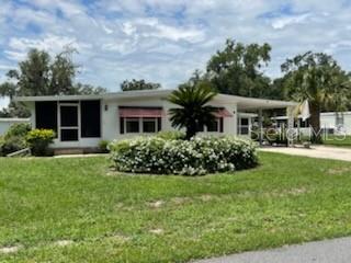 Beautifully Maintained Home with Bonus Room and Tons of Updates - Just Minutes from The Villages! This charming, well kept manufactured home features a spacious and flexible floor plan with the potential for 3 bedrooms, offering over 1,700 sq. ft. of total living space, which includes a bonus room that is not calculated in the original footage of the home. Perfect for relaxing or entertaining, this home is move in ready with major updates completed. Some of the interior upgrades include, freshly painted throughout, brand new flooring, new interior lighting, new drywall, newer windows, A/C approximately 5 years old, roof recently inspected and cleaned, also comes partially furnished. Convenient Features are the spacious foyer with room to bring washer and dryer inside plus plenty of indoor storage space. The Outdoor Highlights are, 8x8 laundry/storage room, 8x12 golf cart garage, 8x8 shed for lawn equipment, 9x10 screened front porch perfect for morning coffee or evening relaxation. Prime location, just 3 miles from Brownwood, The Villages. Enjoy free nightly entertainment, shopping, restaurants and more just minutes away. Our community is located in central Florida, 1 hour east or west you touch the coast, 35 min. north to Ocala, 1 hour south to Orlando and Disney World. We have all the amenities you could want, including that secure feeling with knowing there is a private gated entrance. You'll love living here, I know because I do.