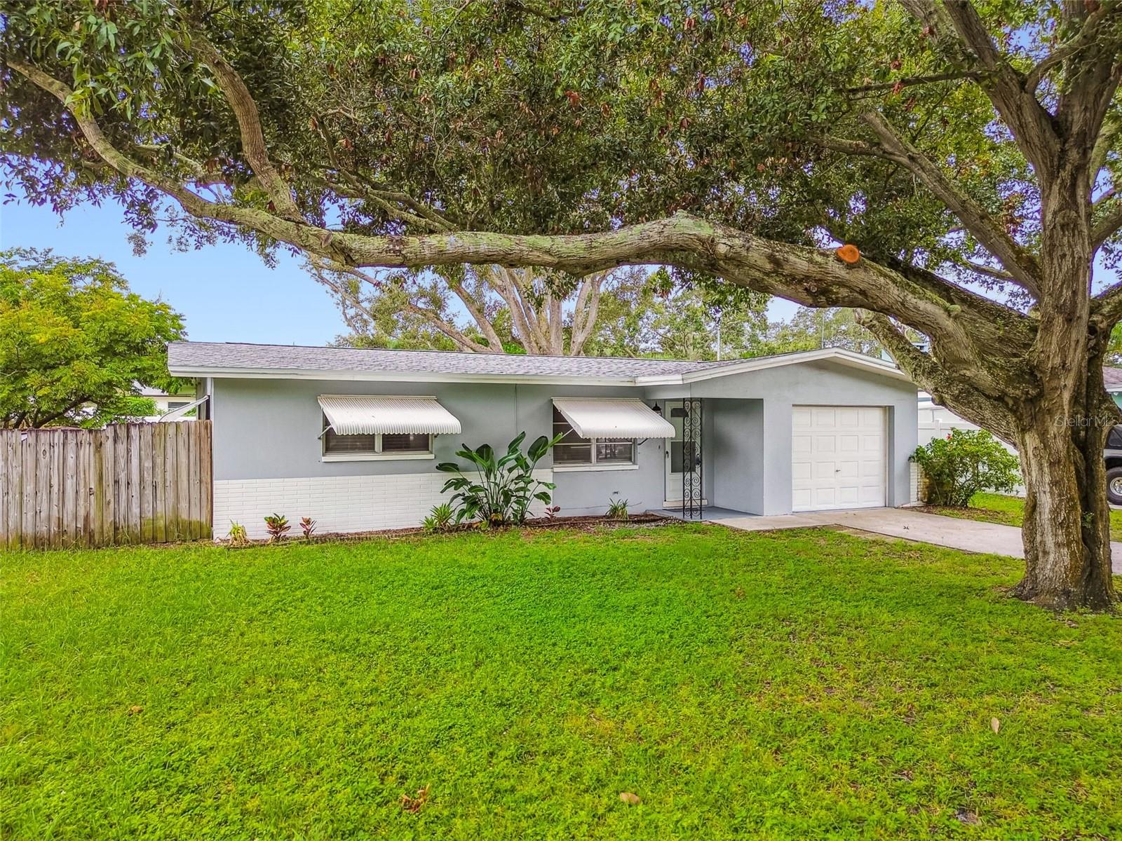 Welcome to 1119 Jackmar Road. This 2-Bedroom, 1-Bath Home is Nestled in Charming Dunedin with No HOA or Flood insurance required. This home features a well planned almost 900 sq ft of living area highlighted by a large Great Room for relaxation and gatherings. The open layout seamlessly connects the living space to the dining area, creating an inviting atmosphere offering a perfect blend of comfort and convenience. 2 Bedrooms share an adjacent Bath with Tub/shower. Worry free with a new roof in August 2025 and luxury vinyl flooring throughout. The screened in patio is a great spot to relax and unwind. Off the patio is the the spacious fenced back yard perfect for entertaining or furry friends with plenty of room to build a Pool and perfect for those with a green thumb for gardening. Just a short distance to Hammock Park, Highlander Park, Kiwanis Sprayground, Dunedin Recreation Center and the Pinellas Trail. Schedule a showing today and enjoy the vibrant lifestyle of this coastal community.