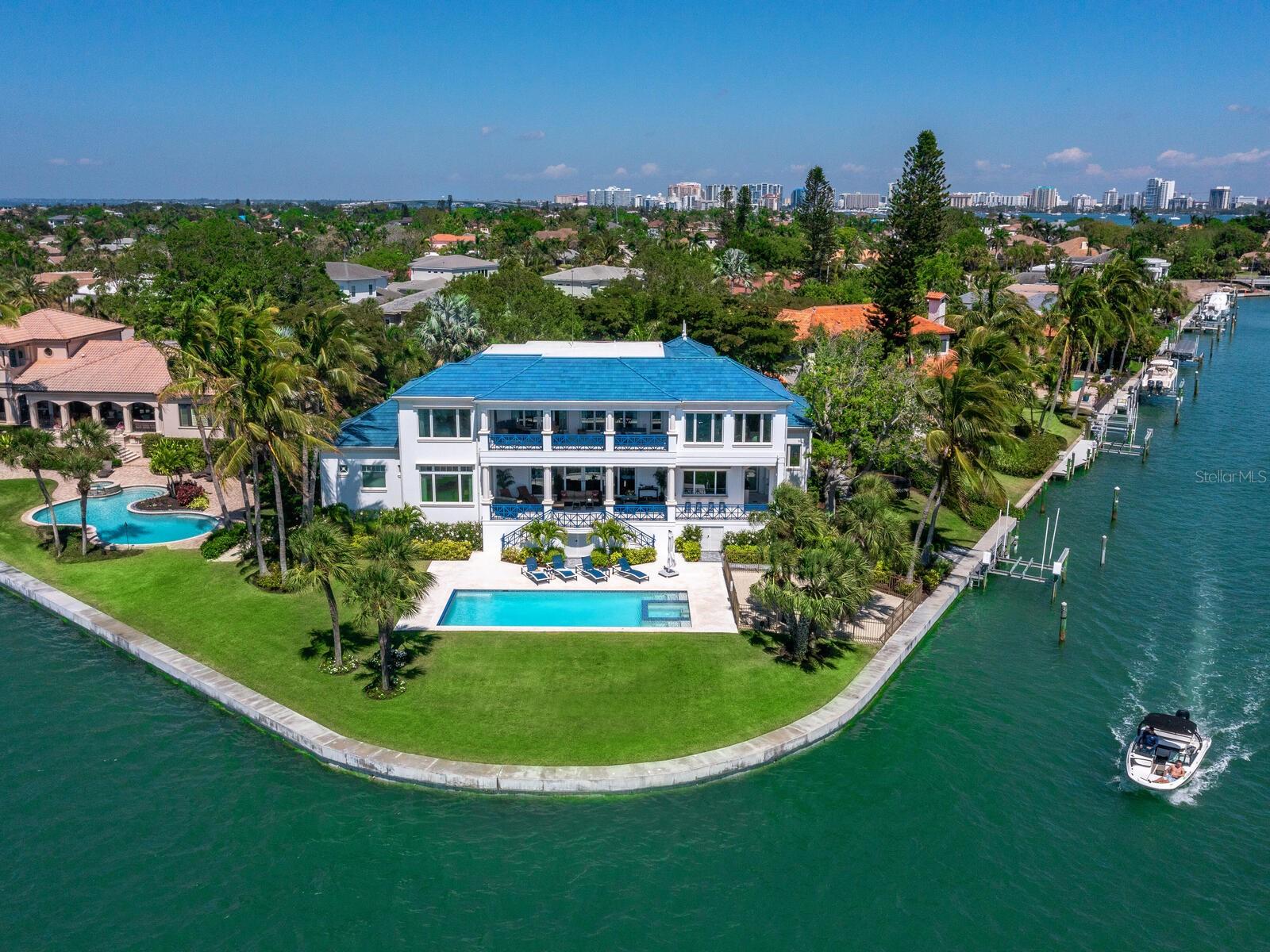 Expansive full bay views south over Lido Key, Big Pass and out to the Gulf of Mexico define this amazing location on Bird Key. Recently constructed of the highest quality, this home features water views from all major rooms with large, covered terraces on both levels. The master suite offers his and hers marble bathrooms that include a steam shower and steep self-cleaning bubble spa tub, fitted walk-in closets, and an exercise room. The focal point of the gourmet kitchen is a stunning La Cornue stove with both electric and gas ovens and gas burners. An adjacent pantry features full cabinetry, prep area, and open shelving. The kitchen opens to the summer kitchen and snack bar seating on the terrace. There is a wine room also adjacent to the great room which opens to the covered terrace through retractable pocketing sliding doors with the push of a button. Abundant space is available upstairs for visiting friends and family members and all rooms open to the second floor terrace overlooking the pool and gorgeous bay views. The bonus room on the second floor is currently being used as a second floor office but could be another Bedroom with it's ensuite full bath by adding a closet. Convenience and safety features include a full backup generator, elevator, and retractable pool cover. There are also two Tesla car chargers in the garage. Quality and comfort abound at this superb location and deserves the attention of all who seek the ideal home in Sarasota. Please review all photography for a full definition of this fabulous residence. Room Feature: Linen Closet In Bath (Primary Bedroom).