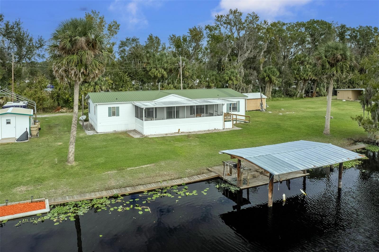 GREAT AIRBNB VACTION RENTAL OPPORTUNITY! Nestled along a peaceful canal with water frontage and direct access to Saint John’s River, this beautifully updated home offers the perfect blend of waterfront living and modern comfort. Surrounded by serene water views and native wildlife, this property is an idyllic retreat with features that impress both inside and out. The property is available furnished also. Step inside to discover a beautifully remodeled interior that perfectly blends comfort and elegance. The living room boasts crown molding and wainscoting, creating an elegant yet cozy atmosphere, and features large windows offering picturesque views of the water. The kitchen is a chef’s delight, showcasing updated cabinets, gleaming granite countertops, and a spacious center island with a butcher-block surface, ideal for meal preparation or casual dining. Adjacent to the kitchen, the dining area seamlessly integrates style and functionality. The master suite includes a fully remodeled en-suite bathroom with a brand-new shower, offering a private and luxurious escape. Additional updates throughout the home ensure a fresh and modern feel, including a redesigned guest bathroom that complements the home’s stylish upgrades. Relax on the screened porch overlooking the canal, where you can enjoy tranquil mornings or evenings watching boats glide by. Just one minute from a convenient boat ramp, the deep canal is perfect for boating and fishing. Whether it’s the quiet atmosphere, access to world-class fishing, or the proximity to Astor’s natural beauty, this property offers the ultimate Florida lifestyle. Make it yours and start living your waterfront dream today.