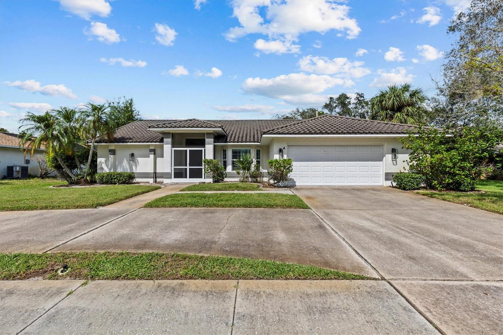 This beautiful pond-front home is nestled in the highly sought-after community of Whitcomb Place, offering both convenience and charm. Just minutes from Sisler Sports Field, Craig Park, Howard Park Beach, Sunset Beach, downtown Tarpon Springs, and the famous Sponge Docks, the location invites you to enjoy an active lifestyle, boutique shopping, and an array of restaurants featuring delicious Greek cuisine.
From the moment you arrive, the home welcomes you with an enclosed screened entry and attractive double doors that open to a thoughtfully designed split-bedroom floor plan. A formal living and dining room create an elegant first impression, with the dining space highlighted by a bay window fitted with plantation shutters. The living room extends gracefully to a screened lanai and saltwater pool, where tranquil pond views provide a serene backdrop.
The kitchen is a true centerpiece, boasting quartz counters, soft-close cabinets, dual pantry closets, and a pass-through window to the lanai. It seamlessly connects to the breakfast nook and family room, creating a bright and inviting atmosphere enhanced by cathedral ceilings and abundant natural light. Smooth rounded wall corners add a custom touch, while energy-efficient windows and disappearing pocket sliding doors blur the line between indoor and outdoor living. From the kitchen, you’ll enjoy a clear view of the pool, and the gas range is perfect for those who love to cook.
Additional highlights include hurricane-rated windows and doors, an impact-resistant garage door, and a hurricane panel system for added protection. The home is topped with a DECRA stone-coated metal roof, installed in 2019 and under transferable warranty, ensuring long-lasting durability. A circular driveway provides easy parking and access, while the garage features a workshop bench and screened doors that allow fresh air to flow freely. With the exterior freshly painted in June 2021, this property has been lovingly maintained and is move-in ready.
This gem combines comfort, style, and peace of mind, making it a home you’ll fall in love with the moment you step inside.