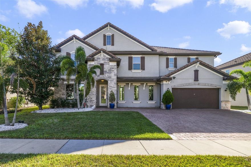 Carefully curated luxury in the sought-after Parkside community! Centrally located for easy access to the Dr Phillips Marketplace, Restaurant Row, top-rated schools and major roadways, this spacious home delivers formal, family and flex spaces, a modern masterpiece in the GOURMET CHEF’S KITCHEN, gorgeous backyard complete with a HEATED POOL and SUMMER KITCHEN, hidden features, tons of storage, and EVERY CUSTOM UPGRADE IMAGINABLE! The impressive TWO-STORY FOYER sets the tone for this light and bright OPEN CONCEPT with site lines straight through to a WALL OF WINDOWS letting the custom accent walls and chic light fixtures shine. The elegant formal dining room allows you to entertain family and friends with ease and the formal living room is versatile in that it could be closed in and used as a 5TH BEDROOM if needed. There is a half bath convenient for guests on the way into the open kitchen and generous family room, both must see spaces thoughtfully designed from floor to ceiling with an ELECTRIC FIREPLACE that adds an unmistakable ambiance to the sophisticated yet comfortable space. Take some time to explore the exceptional kitchen where sleek modern cabinetry is paired with stone counters, upgraded stainless steel appliances, endless storage and some fun ‘hidden’ features. Sliding glass doors open up to an entertainer’s dream oasis, a lanai that runs the entire length of the home with an GLASS ENCLOSED PATIO on one side with a mini-split A/C for maximum comfort and a FULL SUMMER KITCHEN on the other all overlooking the heated pool, pergola, and extensive paver deck, FULLY FENCED for added privacy. The concrete TILE ROOF provides peace of mind and the 3-CAR GARAGE will blow you away with how it has been transformed. As you head upstairs to tour the bedrooms take note of the LUXURY VINYL PLANK WOOD FLOORS that run through the entirety of the home, adding character and warmth to the modern style. At the top of the stairs additional flexible living space awaits in the BONUS/LOFT (could also be an easy conversion to a 5th bedroom), a bright and comfortable place to gather the family with custom accent walls and a built-in nook for your TV. The cherry on top of this designer home is the massive PRIMARY SUITE delivering a tranquil retreat for the new owner with another custom accent wall, its own electric fireplace, large SITTING AREA, well appointed private en-suite bath and huge WALK-IN CLOSET with CUSTOM BUILT-IN’S to organize until your hearts content. This immaculately maintained community enjoys an array of AMENITIES, from the clubhouse, community pool, playground or tennis courts - there is something for everyone. Call today to schedule a tour and fall head over heels in love with this stunning home on Chilton Drive!