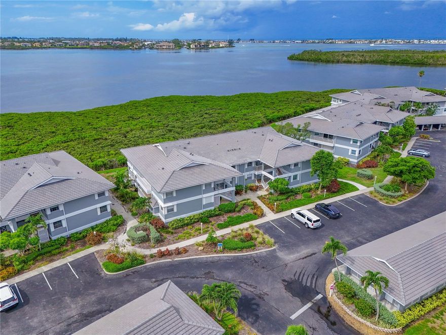 Welcome to this stunning 3BR/2BA waterfront condo in the coveted, gated community of Perico Bay Club—just minutes from Holmes Beach and Anna Maria Island! This recently updated unit offers breathtaking panoramas of Palma Sola Bay and the Intercoastal Waterway. It's a must see, the pictures don't do it justice! Over $100K in high-end renovations were completed in 2021–2022, including a completely redesigned chef’s kitchen with quartz countertops, soft-close wood cabinetry, stainless steel appliances, glass tile backsplash, breakfast bar, and updated lighting. Walls were removed to create a bright, open-concept layout with seamless flow throughout the main living spaces. Stylish wood-look tile flooring, updated baseboards, and fresh paint elevate the interior. The primary suite features high ceilings, water views, sliding doors to the lanai, and a luxurious, remodeled ensuite bath with a custom shower nook. The guest bathroom has also been beautifully updated. Additional upgrades 2021: new AC unit , hurricane shutters, rescreened lanai, private 1-car garage, and plenty of in-unit storage. This home is steps from one of the community pools. Community amenities include 24/7 security, a clubhouse, two heated pools, fitness center, tennis and pickleball courts, library, kayak launch, walking paths, and more. Recent community improvements include a new roof, freshly painted exterior, and repaved parking areas. This is your chance to own a coastal retreat in one of the area's most sought-after communities. Don't miss it!