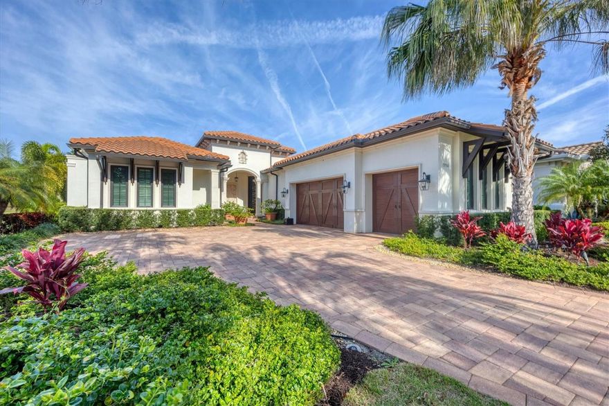 Welcome to this stunning custom courtyard home in the Matera neighborhood of the Lake Club, a Tuscan-inspired community. The front entry features 10-foot wrought iron doors, a travertine wall feature and beautiful imported terra-cotta pots. The home has multiple 10-foot-tall patio doors creating seamless indoor/outdoor living. The spacious outdoor living area is complete with a colonnade screen enclosure, multiple seating areas, custom pool/spa, built-in fire pit and deluxe outdoor kitchen. The dining room has wonderful views of the outdoors through sliders which open wide. All 10-foot tall patio doors have automated roll-down shades. All windows have custom wooden plantation shutters. There are 10-foot ceilings throughout the home and a 14-foot ceiling in the great room with wood beams extending through to the outdoor seating area. Wood floors are throughout the main living areas and all interior doors are solid core. The spacious kitchen has floor-to-ceiling custom cabinetry, an oversized center island, granite countertops, large walk-in pantry, designer tile backsplash, stainless steel appliances and APEC kitchen RO system. The primary bedroom features double French doors to the lanai and two oversized walk-in closets. The primary bath includes separate dual vanities, soaking tub and oversized walk-in glass enclosure shower. The guest suite has two wall closets and private bath. The casita includes its own private front entrance, sliders for easy pool access and guest bath which doubles as a pool bath. The den has 10-foot sliders with disappearing corner allowing access to the casita and outdoor living. The back hallway features separate laundry room with front loading washer and dryer, 2 utility closets and drop zone. The oversized 3-car garage includes custom wood doors, Florida basement for storage and a tankless hot water heater (new 2023). The home includes impact windows and sliders, a Kohler power system full-house generator and attic spray foam insulation. The Matera neighborhood HOA fees include yard and pool maintenance. The Lake Club community offers a grand club house with fine dining, multiple pools, fitness facilities, tennis and pickleball courts, and the best of Lakewood Ranch’s lifestyle.