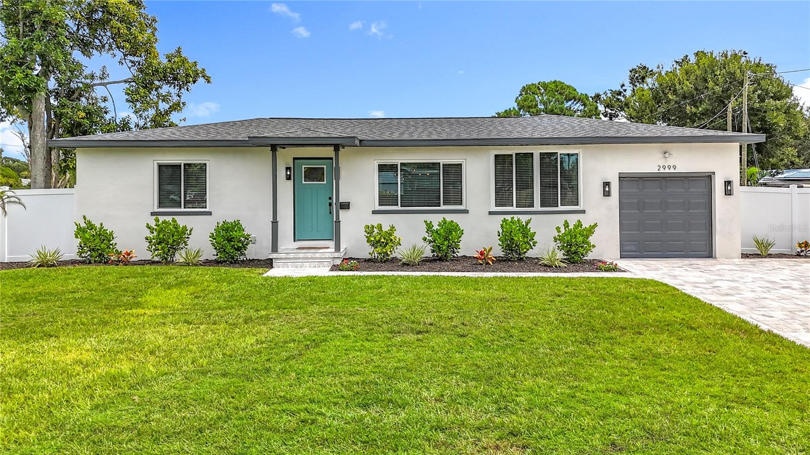Fully renovated, this home features All NEW: Roof, HVAC system (including ductwork), Electrical (including panel), Plumbing (supply, and sewer lines), energy-efficient tankless water heater, appliances, insulation, hurricane-impact doors, and all newer hurricane-impact windows - creating a truly energy-efficient and safe home. Welcome to this immaculate 3-bedroom, 2-bathroom home located in the desirable neighborhood of Disston Heights / Leslee Lake. With 1,449 SF of living space, this home greets you with an abundance of natural light, waterproof LVP flooring, and LED lighting. The well-appointed kitchen features an expansive island with seating for four, new upgraded stainless steel appliances, custom soft-close solid wood shaker cabinets, a pantry, Venatino Carrara quartz countertops, a range hood, a stylish tile backsplash, and decorative lighting. The living room, dining room, and kitchen provide a perfect setting for gatherings with family and friends, with an additional sitting nook off the dining space. The large primary bedroom with his and her closets is the ultimate owner’s retreat, complete with a custom, oversized en-suite bathroom featuring a walk-in shower with a custom niche, a large oak double-sink vanity with built-in electric outlet, and a luxury freestanding soaking tub with a show-stopping chandelier. The two additional bedrooms are bright and welcoming with nice-sized closets. The guest bathroom includes a shower-tub combo. Both bathrooms boast spa-like features, including porcelain tile, quartz countertops, and oversized rain shower heads with separate handheld sprayers. Just off the dining area is the laundry closet, complete with a new large high-efficiency LG stackable washer and dryer. Step outside to the oversized backyard, complete with a new paver patio and bistro lighting - perfect for evenings under the stars. The extremely large 9,209 SF corner lot has been freshly landscaped and has a new vinyl fence offering privacy and plenty of room for a pool if desired. The right side of the yard features a double gate and has plenty of space to allow you to store your boat, RV, or both if wanted. The 1-car garage and the new oversized paver driveway can accommodate you and all your guests. Situated in a scenic neighborhood with a lake and in a NON-FLOOD ZONE, high and dry with over 60 feet of elevation, this is an ideal location for walking or biking, and is just minutes from shopping, dining, parks, downtown St. Pete, airports, and Florida’s iconic beaches. Fully permitted and untouched by hurricane damage or flooding, this move-in-ready home offers peace of mind, style, and function. Schedule your showing today - this home won’t last long.