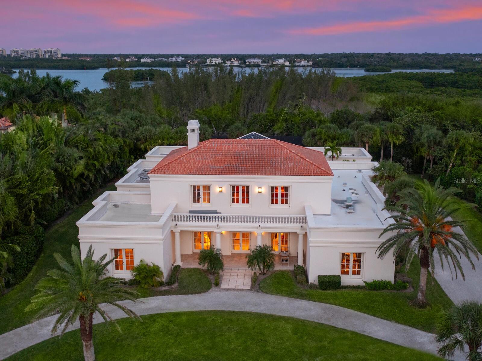 Along the beaches of Casey Key, a private gated road leads to the exclusive northern end of this coveted barrier island. Sited on nearly 2.5 acres and 150 feet of private beach front, lies a spectacular estate home that has been shared and enjoyed by one family for generations. Designed by renowned architect Timothy Siebert, the property was thoughtfully planned as a gathering place. Wrapped around the inner courtyard, 6 en-suite bedrooms, 7 and 1 half baths, provide guests with access to a resurfaced pool, spa and tennis court and their own private retreats. High ceilings throughout emphasize the grandeur of the spacious rooms. The large kitchen and formal dining rooms are ideal for preparing and serving every culinary delight. Stepping across the expansive front lawn, enhanced with exotic palms, a private boardwalk leads to the powdered sugar quartz sand beach. One can walk for miles with turquoise blue water along the Gulf of Mexico or enjoy a place to rest on the shore with a fabulous book. With no public beach access for miles, guests are pleasantly surprised how quiet and seemingly uninhabited Casey Key remains. Designated as a conservation district by the State of Florida, building is reserved for single family homes. There are no high rises or condominiums permitted and the reputation for its natural beauty and elegance will be retained for generations to come. Private and commercial air travel in nearby Venice and Sarasota are so convenient. Shopping, golf and restaurants are all easily accessible making this destination nearly too good to be true. One of the Sarasota areas most exclusive addresses, North Casey Key will not disappoint.