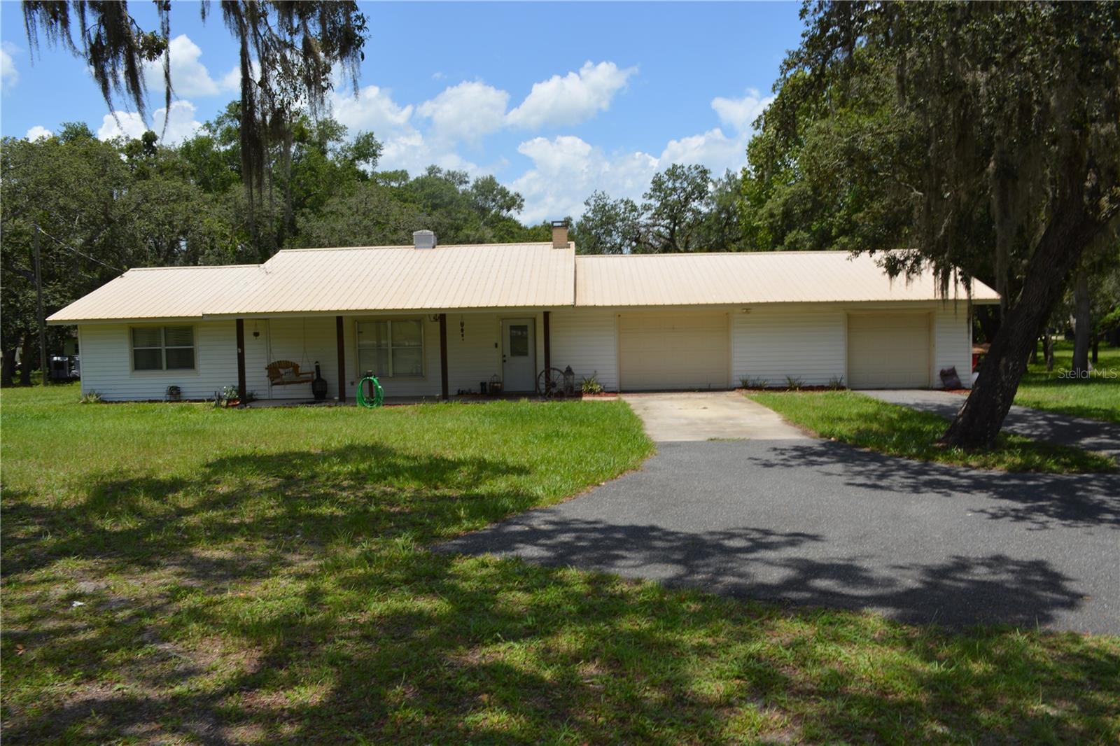 This completely fenced corner lot offers 3 separate parcels, total approximately 3.25 acres, and provides you with plenty of room to spread out, bring your toys with no HOA restrictions and you can have fun. This 2-bedroom, 2-bathroom house offers a large living room with crown molding, wainscoting, vinyl plank flooring, with an electric fireplace. The kitchen, equipped with granite countertops, excess wood cabinets for plenty of storage, the dining areas are located just off the living room and provides for excellent entertaining with plenty of room. The AC was installed in 2023, water heater in 2020. The oversized 2-car garage provides additional storage space. Outdoors you will find a very large front yard with mature landscaping, large trees for plenty of shade.